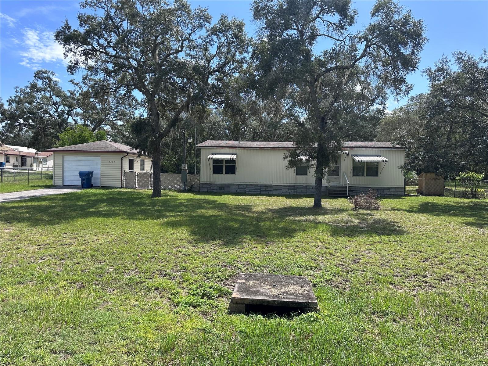 Welcome to 3268 Baldwin St. This 1986 double wide mobile home sits on a little over an acre of land with endless possibilities. The electrical book and breakers have just been updated as well. The mobile home has been meticulously maintained. It features two spacious bedrooms and two baths with the primary bedroom having the bath on-suite. There are large closets in both bedrooms as well as ceiling fans and plenty of lighting. The sun room on the back of the mobile home has recently updated vinyl windows making it a perfect spot to relax or entertain all year long. The sunroom also features washer/dryer hookup. The garage has been converted into a one bedroom in law suite with a recently updated walk in shower. The unit has a cooktop, in window AC unit, refrigerator, a newer hot water heater and its own well. The garage door is still functional so if you wanted to use it as a workshop or to park a car you still could. This property is situated so that you can enjoy as much of the land as possible. Towards the back of the property there is another shed that is equipped with electricity as well. With no HOA you can park boats, RV’s or semi’s on your own land without paying for storage. This property has so much potential and is ready for its new owner. Schedule your appointment to see it today.