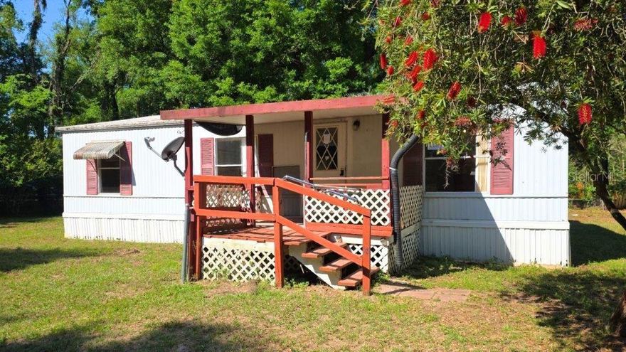 Charming opportunity in a prime location! This 2-bedroom, 2-bath mobile home sits on a spacious .25-acre corner lot in Belleview, FL, just a short drive from The Villages, Big Lake Weir, and Carney Island State Park. This home offers great potential and features an open floor plan with vaulted ceilings, creating a bright and airy feel throughout. The open kitchen overlooks the family room, with a dining area conveniently located just off the kitchen, plus a separate living room for flexible living options. Enjoy outdoor living on the covered front porch, surrounded by mature trees and established landscaping that provide shade and privacy. With plenty of space inside and out, this property is ideal for buyers looking to make it their own or invest in a home in a desirable and growing area. Don’t miss this opportunity to own a property in a fantastic location! All information recorded in the MLS is intended to be accurate but cannot be guaranteed, buyer advised to verify. Sold As-Is. Listing agent has no knowledge of property or disclosures.