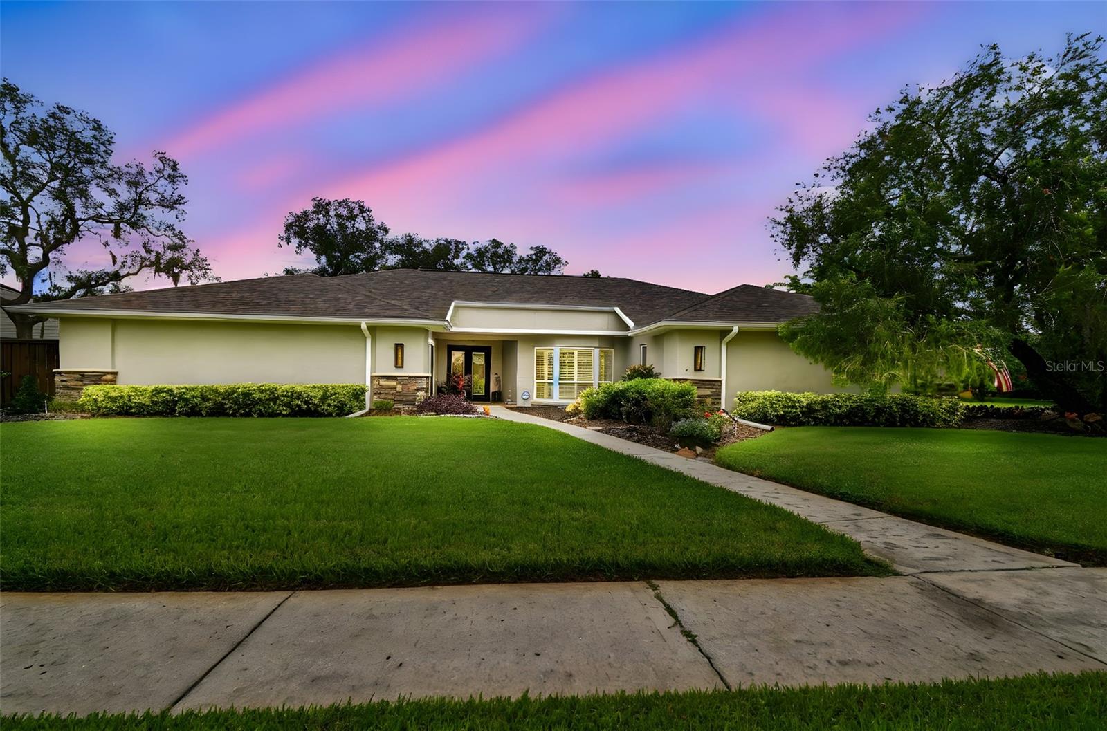 Welcome to 5009 Chattam Lane, a residence where everyday living feels like a retreat. Perfectly positioned on a quiet cul-de-sac street in the highly sought-after Phase 3 of Carrollwood Village, this elegant home rests on a rare oversized lot, offering both privacy and a sense of connection. From the moment you step inside, the home feels both elegant and inviting. The renovated kitchen opens effortlessly to the family room, where daily routines and celebrations come together with ease. The redesigned foyer and den create a graceful welcome, while the primary suite invites you to unwind in a spa-inspired bath and custom dressing room. New flooring throughout connects each space, balancing style with comfort for the way you live today. Beyond its beauty, every detail has been thoughtfully addressed. A newer roof, impact-rated windows and sliders, and updated electrical and HVAC systems bring peace of mind. Whole-home features such as surge protection, upgraded insulation, and water purification add comfort you can count on. Step outside, and the lifestyle unfolds. The heated pool, updated with new equipment, resurfaced decking, and a refreshed enclosure, becomes the centerpiece for weekends at home. A koi pond shimmers nearby, while the detached guest house offers flexible space for hosting, working, or for relaxing. Life in Carrollwood Village extends well beyond your front door, enjoy morning walks through tree-lined streets, afternoons on the tennis courts, and evenings exploring dining and shops just minutes away. 5009 Chattam Lane is not just a residence, it is a place to gather, recharge, and create lasting memories.