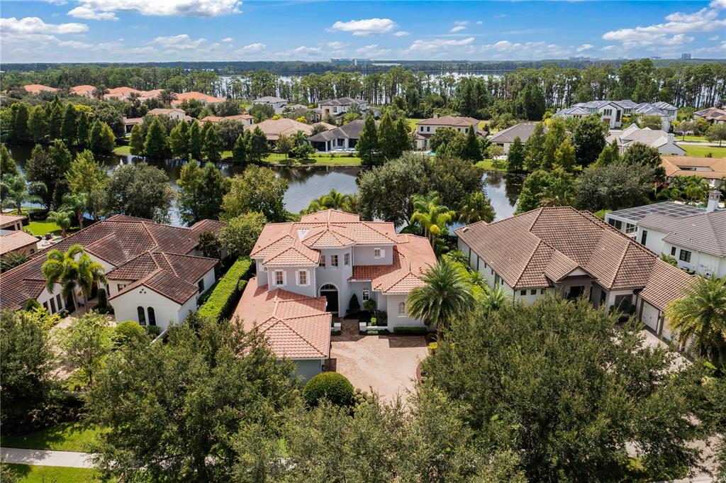 This ISSA home was built in 2012 and with the original owners only here part-time, there is literally zero wear on anything. This home is like brand new and has one of the best floor plans around. Situated on a third of an acre overlooking a gorgeous pond, this nearly 5,100 SF home boasts 5 BR’s, all with private En-Suite Baths, a Powder Bath, Dedicated Office, Upstairs Loft, 3-Car Garage, Private Pool & Spa and covered outdoor entertainment area with Summer Kitchen and remote shade screens. You will not be disappointed when you enter the double front doors to see glamorous travertine floors with intricate wood inlays, detailed tile design, soaring ceilings and tremendous natural light. Downstairs, you can enjoy all of your living with your grande formal dining room, formal living room with gas fireplace, cozy family room and gourmet kitchen. Also downstairs, you have your Office with glass French Doors overlooking the pool and pond, a large Master Suite with Breakfast Bar, 3 Closets, a huge Master Bath with walk-thru shower, dual vanities and enormous garden tub. Conveniently, you have a second BR down along with the utility room and Powder Room. Enjoy the quality of this home as you walk up the wooden staircase to the loft entertainment area along with 3 additional BR’s, all with private Baths. This home is lovely on the inside but the outdoor living is amazing with the pool & spa, tremendous open paver deck space for lounging in the sun and a generous covered lanai for dining, cooking out, watching football and more. Enjoy the Lake Nona Golf and Country Club Lifestyle which is second to none. All A-rated schools, minutes from Orlando's International Airport, Medical City, Boxi Park, shopping, restaurants, the 417 Greenway, 528 Beachline offering easy access to anywhere! Don’t miss out on this opportunity!