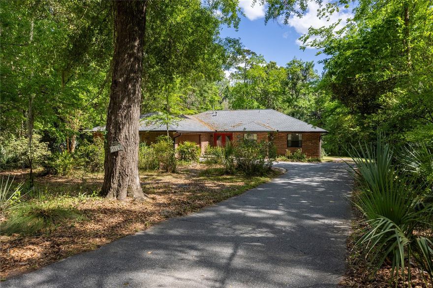 Welcome to this beautifully maintained 3-bedroom, 2-bath home offering approximately 2,100 square feet of living space, ideally situated on over 1 acre (and on the creek) in the highly sought after Rock Creek community. This property combines peaceful, nature-filled surroundings with a central location convenient to everyday amenities. The home features a functional and spacious layout, including formal living and dining rooms, as well as a comfortable family room with a gas fireplace—perfect for everyday living and entertaining. A whole house fan enhances energy efficiency and year-round comfort. Enjoy exceptional outdoor living with a full-length back deck spanning the home and overlooking the expansive yard—an ideal setting for morning coffee, relaxing evenings, or entertaining guests. An additional oversized concrete patio offers even more space for gatherings and outdoor enjoyment. The partially fenced yard provides a great area for pets, while the natural setting invites you to explore and enjoy the beauty of Three Lakes Creek right from your own backyard.  The oversized 2-car garage provides ample space for parking, storage, or hobbies. New roof installed in 2023.  Offering a rare combination of privacy, space, and convenience, this property is a true retreat while still being close to everything you need. Seller is offering a $10,000 credit toward sliding door repairs.