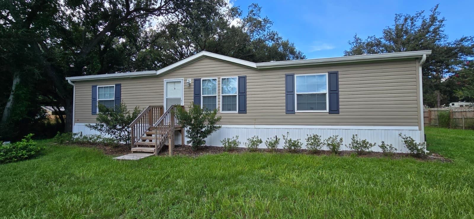 Welcome to this nearly new 3-bedroom, 2-bathroom manufactured home, built in 2023 and nestled on a spacious 0.98-acre lot in the peaceful Country Road Subdivision of Lake County. Offering open living space, this home combines modern comfort with serene surroundings—perfect for long-term living.
Step inside to discover an open floor plan featuring ceiling fans, central A/C and heat, and a laundry closet with washer and dryer included. The kitchen comes fully equipped with essential appliances, including a dishwasher, microwave, range, and refrigerator—ideal for everyday living and entertaining.
The primary suite includes its own private bath, and all bedrooms are generously sized. Enjoy the privacy of rural living while still being conveniently located near local schools, shopping, and major roadways. To apply visit: https://apply.link/L2-xy90