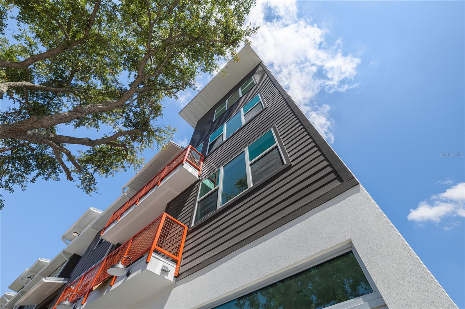 Prime eastern end unit at Driftwood on Central. A fully leased, cash-flowing mixed-use townhome in the heart of St. Petersburg’s thriving Grand Central District. This contemporary end unit features a priceless, new 12-foot elevation commercial storefront with a bathroom on Central Avenue, currently leased and producing income, with a beautifully appointed three-bedroom, three-and-a-half-bath residence above. Designed for modern living and long-term investment, the home features 10-foot ceilings, expansive private balcony overlooking Central Avenue, impact-resistant windows, quartz countertops, large plank tile in wet areas, full-height subway tile showers, upgraded appliances including a gas range, and a spacious entertainer’s kitchen island. Located in a high-elevation X500 flood zone, this fee-simple property combines low-maintenance new construction with prime urban frontage. Surrounded by vibrant dining, boutique shopping, and cultural attractions, this is a rare opportunity to own a turnkey income property with exceptional long-term appreciation potential in one of St. Pete’s most dynamic growth corridors.