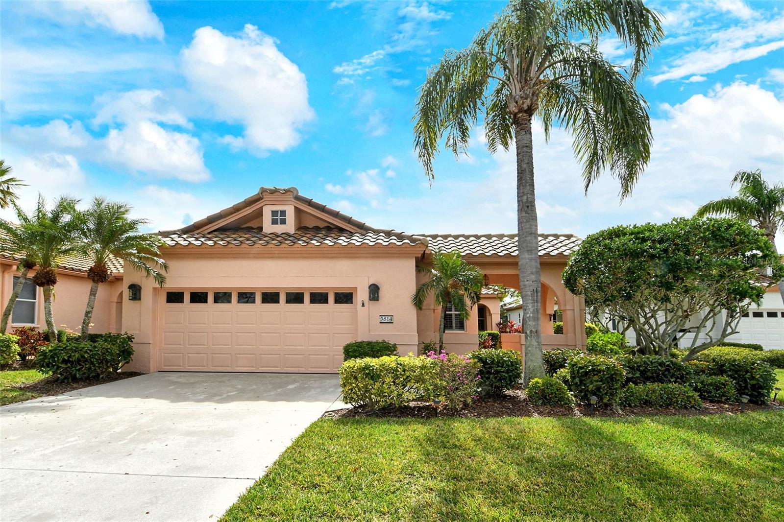 One or more photo(s) has been virtually staged. The boutique, maintenance-free, gated community of Mira Lago at Palmer Ranch offers a rare opportunity to own a three-bedroom, 2.5-bath home! This residence was re-roofed with new barrel tile in 2021, and a tankless water heater was installed in 2023. The air conditioner was replaced in 2018 for added comfort. The main living area features beautiful hardwood floors, high ceilings and plantation shutters throughout. The kitchen is a highlight, with 42-inch cabinetry, granite countertops and stainless steel appliances, including a double sink. A charming breakfast nook is tucked within the kitchen, and a pantry closet provides plenty of food storage. The laundry room, with a utility sink, is conveniently off the kitchen, just outside the oversized garage, which boasts ample storage cabinetry and a workbench. The split floor plan of this Encino model places the primary bedroom at the rear of the home, off the Florida room. It features a spacious walk-in closet and a custom-built armoire cabinet for linen storage. The en-suite bath is a retreat, with a jetted garden tub, a walk-in shower with stunning travertine tile and onyx trim, dual vanities, and wood cabinetry with granite countertops. The second bedroom is connected to a pocket door, making the second bath an en suite as well, along with a hall closet. This bathroom is beautifully appointed with high-end cabinetry, walk-in shower tile finishes, and wood cabinetry with granite countertops. The third guest bedroom includes built-in office space with a large desk area, a walk-in closet and an en-suite half bath. Low HOA fees cover security gate, grass cutting, irrigation, mulching, tree trimming, power washing of driveways, sidewalks and roofs, exterior painting every eight years, interior pest control, and 120 Frontier cable TV stations. At the northwest corner of Palmer Ranch, you’ll be just minutes from Siesta Key, Gulf Gate and downtown Sarasota, with easy access to everything the area has to offer!
