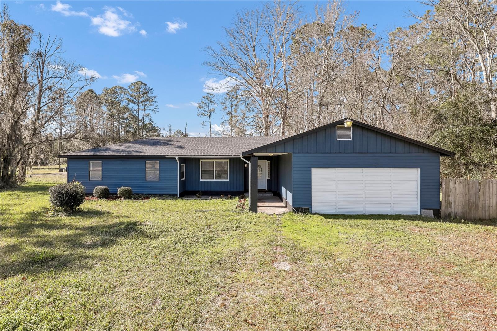PRICE REDUCTION!* 1 ACRE ** FULLY RENOVATED ** BRING YOUR CHICKENS This 1-acre property offers the perfect blend of modern comfort and natural beauty. With its bright, airy interior featuring all-white walls, stylish lighting fixtures, and wood-like vinyl plank flooring, this home is a true gem. Enjoy ample space for entertaining and relaxation with a huge deck and expansive b