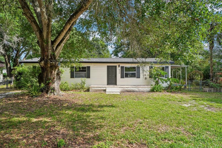 Welcome to this charming 3-bedroom, 2-bathroom single-family home located at 620 2nd St in the heart of Polk City, FL. Offering 1,012 sq. ft. of living space, this residence boasts a bright and open-concept layout with stylish light wood-tone LVP flooring, a neutral color palette, and abundant natural light. The beautifully appointed kitchen is equipped with crisp white shaker cabinets, sleek black hardware, modern white countertops, and a striking black faucet, flowing seamlessly into a spacious living and dining area perfect for everyday living and entertaining guests. A versatile enclosed sunroom/flex space with plush carpeting offers a cozy indoor retreat, while the dedicated utility room provides convenient laundry hookups. Step outside onto the inviting wooden front deck to enjoy the Florida breeze, or take advantage of the generous lot size with mature trees and plenty of outdoor space. Perfectly situated close to local schools, parks, and offering easy access to major routes between Lakeland and Orlando, this move-in-ready home is ready for its next chapter.