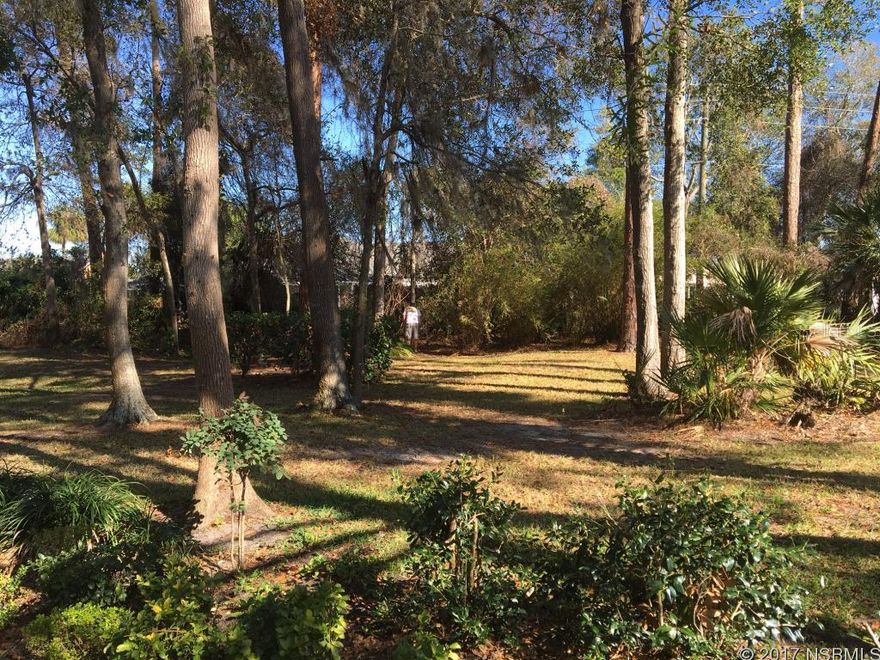 Location, location! Very unique property. Pull into your circular driveway set back on a peaceful wood lot. Almost 1 acre! Classic wood garage doors and huge 30x26 garage. This 3 bedroom, 2 bath with wood floors & doors throughout is located blocks from Spruce Creek High School. Family room is open to kitchen w/breakfast bar & newer appliances. Formal Dining/Living room. Both baths have tile and walk-in showers, granite counter tops, with elegant trim and dÃ©cor. Enclosed, air-conditioned Florida room. Pocket doors, tons of closet space throughout. Quaint brick pump house, spacious grounds with trees & 25'x13' patio. Pristine, very well maintained property. An absolute Must See! All information recorded in the MLS is intended to be accurate but cannot be guaranteed. ;Water: City