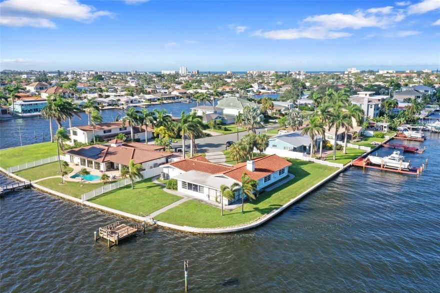 Build your dream home here!!  Rarely available, end of cul-de-sac, oversized lot with 240 feet of waterfrontage. The current home has 2 bedrooms, 2 baths and a 2 car garage with a tile roof.  But, this one is all about the lot! Located on Capri Isle at the end of a quiet cul-de-sac, surrounded by beautiful waterfront homes.  With over 240 linear feet of waterfront you will enjoy endless views of the intracoastal waterway to the north, south, east and west!  Just a few minutes by water to the Gulf of Mexico and directly on the Intracoastal Waterway provides for some of the very best boating access on the west coast of Florida. You'll revel in the sights of this amazing waterfront location - watch dolphins and manatees pass by, watch birds of many species, view sunrises and sunsets - all from your piece of paradise. Capri Isle is a serene waterfront neighborhood of waterfront homes and this lot is certainly one of the premier lots in the area.  The oversized lot allows you to construct a substantial home, befitting the terrific location, with room for a pool and a place to keep a boat of nearly any size right in your own backyard. There are not many lots like this anywhere and they aren't offered for sale very often. Don't miss the chance to own this once-in-a-decade type of property.