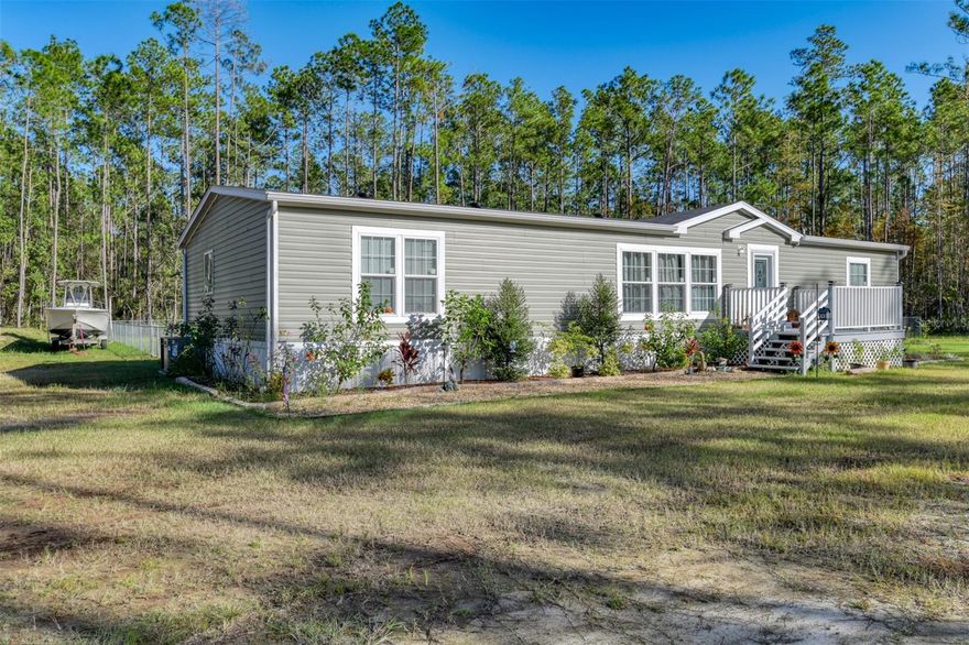 Back on the market and listed below the current appraised value!!! Come see this meticulously maintained double wide mobile home on a large cleared 2+ acre corner lot in Flagler Estates! The spacious 1980 square foot interior offers 3 beds / 2 baths, vinyl plan floors throughout, fresh paint, oversized pantry with custom shelving, and stainless steel appliances. Outside you'll find a fenced back yard, 42x22 back deck, fire-pit, large above ground pool, and a detached 25x30 garage / workshop with a 12ft door that's perfect for your 5th wheel or RV. The well has been upgraded with a softener and filtration system, and additional drainage was added to the south end of the property. With no HOA/CDD to worry about, you can bring your boat, RV, and 4 wheelers. This slice of paradise is perfect for someone looking to enjoy life in a more rural setting where you can relax in the peace and tranquility of all that Northeast Florida nature has to offer. Schedule a showing today because homes are going fast in Flagler Estates!!!
