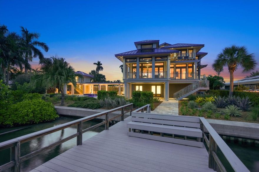 AWARD-WINNING ENERGY EFFICIENT HOME IS HERE!!  This home was designed and built as a one-of-a-kind luxury home equipped for eco-conscious living with a minimal carbon footprint. This stunning Euro-modern designed waterfront home was built with sustainability as a priority without sparing aesthetics or luxury.  This home won HOME OF THE YEAR at the Florida Green Builders annual event. Every piece of equipment, every appliance, even the European lifestyle was factored into the energy optimization model.  The result was a truly green home that exceeds today’s standards, scoring a -9 HERS rating of energy efficiency. The home is completely sustained on solar power with battery storage, LED lighting throughout, and captured rainwater used for landscape systems.  Extraordinary technology is available at the touch of a button for most features. Materials used to build the home are recycled or locally sourced. In addition, this home is made of steel and concrete, able to withstand threats of gale force winds and water.

The interior was designed by Marilyn Whitney utilizing eco-friendly materials to create an open living space that reflects the intentional green practices of the home. The floor plan is also a Universal design, for all stages of life and mobility – you will find no hallways or thresholds in the flooring.   This unique property, sits majestically on a spacious double lot, boasts 3,215 heated sq ft, including 3 bedrooms and 3.5 baths. The interior showcases a European-style design, harmoniously blending natural woods and concrete flooring, creating a perfect blend of chic and comfort. At the heart of this home lies an open-plan living area, complete with an automated lighting & sound system that enhances the ambiance at the touch of a button. The kitchen is equipped with high-end appliances from Wolf, Miele, and SubZero, ensuring a superior culinary experience, truly a chef's dream.

Outside, the expansive backyard is ready for entertaining with multiple patio areas, complete with a heated/chilled pool, spa, and bath house. It also offers ample space for an outdoor kitchen installation. The dock is ready to install a lift for your boat of choice to head out onto Boca Ciega Bay. Overhangs extend 3 feet to provide shade to all windows, while doors and windows are insulated with impact rated low-e glass and feature "tilt and turn" ventilation options.

Enjoy quiet mornings out on the balcony gazing at the spectacular intracoastal waterways!  Lower the screens to fully enclose the patio to eliminate any pests. Need more water views? Head to the crow’s nest at the home’s highest point to see 360 degrees or take in a captivating sunset from the upper balcony as you enjoy happy hour with a nice glass of merlot. Built intentionally, no detail has been spared in this home’s construction, resulting in a remarkable opportunity for the new owners.  Make the move today, it doesn't get any better than this!