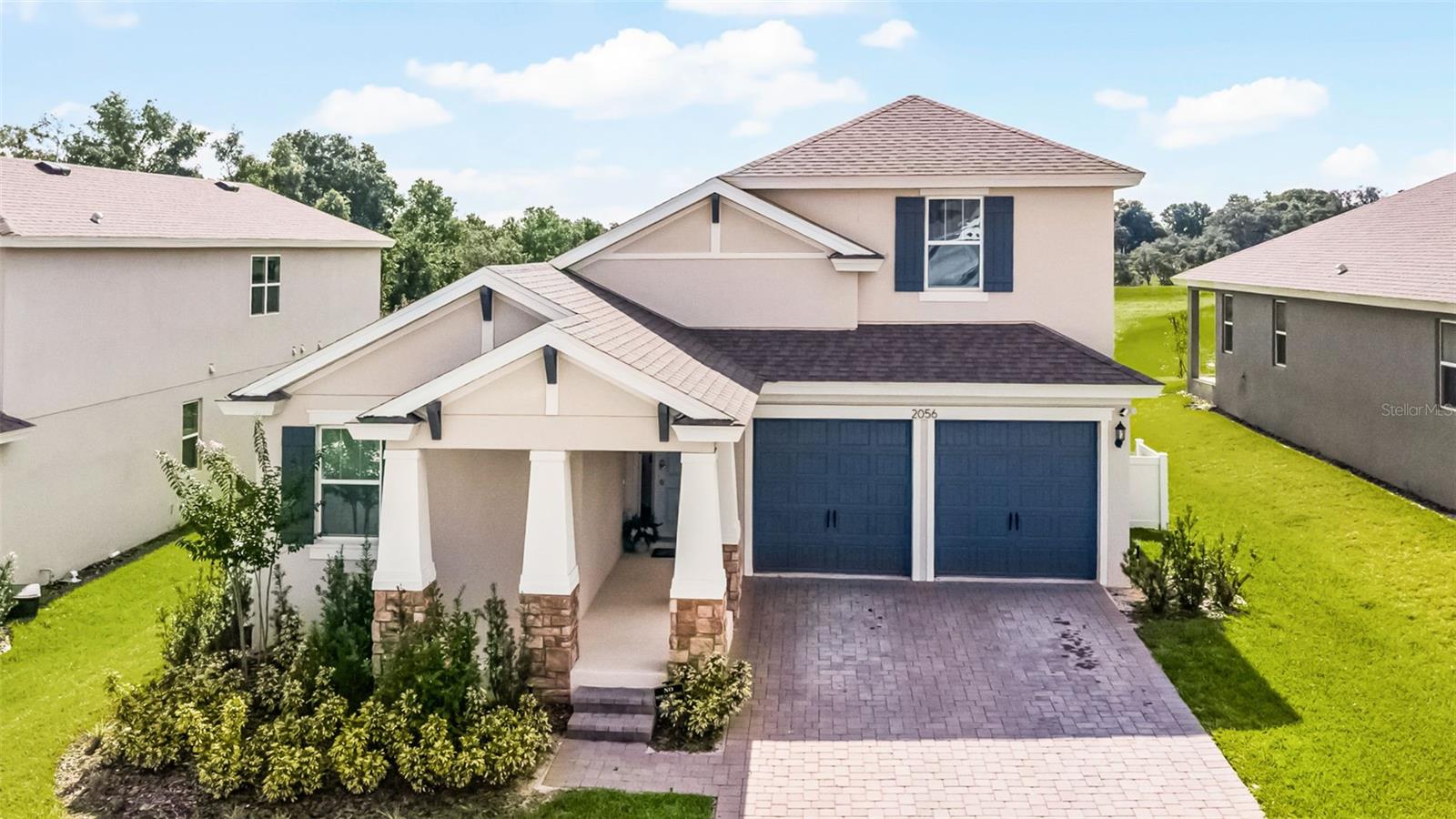 Built in 2024. 2056 Keystone Pass Blvd in beautiful Minneola, FL, a stunning two-story modern home offering 6 spacious bedrooms, an open-concept layout, and abundant natural light throughout. The bright, gourmet kitchen features vibrant cabinetry, solid wood cabinets, elegant stone countertops, and a sleek range hood, perfect for both daily living and entertaining. The primary suite is conveniently located on the first floor, providing a private retreat, while the backyard offers peaceful serenity with no rear neighbors. Located just 8 minutes from Target with a Starbucks Café, this home also sits just steps away from the brand-new Minneola Hills K-8 Academy, making school drop-offs a breeze. Other top-rated schools nearby include Grassy Lake Elementary (4 minutes), Lake Minneola High School (5 minutes), and East Ridge Middle School (9 minutes). Outdoor lovers will enjoy close proximity to Lake Minneola Scenic Trail & Waterfront Park (7 minutes), Minneola Trailhead Park (6 minutes), and Lake Louisa State Park (15 minutes), offering endless opportunities for recreation and natural beauty. As a bonus, you’re only 6 minutes away from DreamCatcher Alpacas Farm, and 3 minutes away from the Turnpike!— a local hidden gem perfect for a unique and fun weekend outing. This home is more than just a place to live — it’s an invitation to a lifestyle of comfort, connection, and charm in one of Central Florida’s most serene and fast-growing communities. Make your appointment today and start planning your future home now — the perfect blend of modern living and natural beauty is waiting for you.