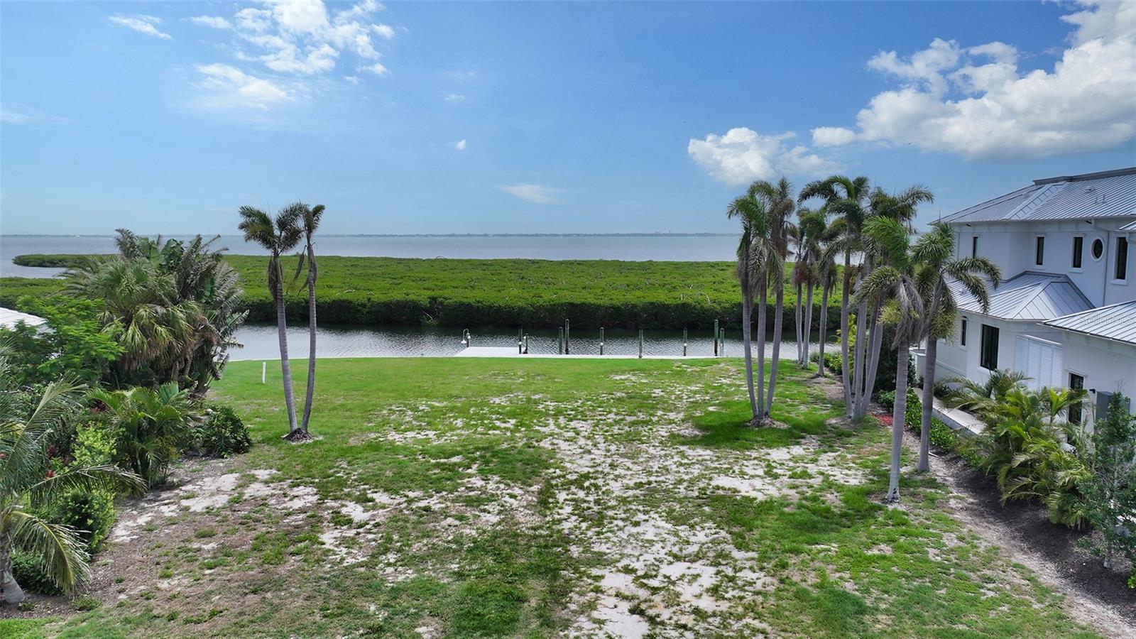 Rarely available Bay Isles Harbor bayfront lot. Enjoy incredible sweeping Sarasota Bay views in the prestigious Harbor section of Bay Isles. The property is at the end of a cul-de-sac on an oversized 16,000-square-foot lot with 150 feet of canal frontage overlooking Sarasota Bay. This is an incredible opportunity to build your dream residence on an extraordinary Bay Isles Harbor Lot with panoramic Sarasota Bay views. Owners enjoy the private Bay Isles lifestyle behind the gates, with access to the Bay Isles Beach Club and Longboat Key Club's Harbourside Golf Course, Tennis Gardens and other amenities available to club members. Architect renderings available.