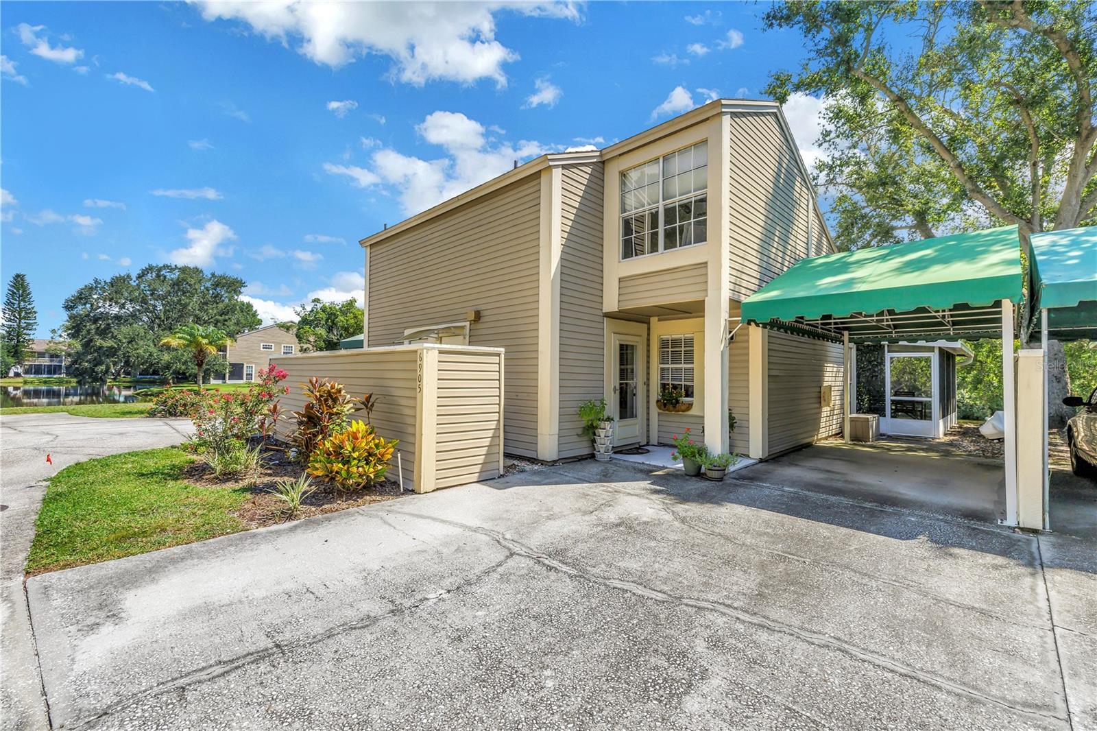 Nestled in the desirable gated community of Lake Place, this fully updated 2-bedroom, 2.5-bathroom townhouse is truly a must see! Step inside to a beautifully renovated kitchen complete with granite countertops, wood cabinetry, stainless-steel appliances, and even a wine-bar refrigerator. The first floor features rich real wood flooring that flows into the spacious living area, highlighted by a screened oversized patio with serene lake views - perfect for relaxing or entertaining. Upstairs, you'll find newer laminate flooring in a private master suite with its own lake-view balcony, and a luxury en-suite bath. The second bedroom is also an en-suite with an equally impressive oversized closet. Additional conveniences include washer/dryer hookups and access to the sparkling community pool. Perfectly located near the airport, Veteran's Expressway, and Citrus Park Mall, this gem offers both style and convenience. Homes like this rarely last. Schedule your showing today before it's gone!