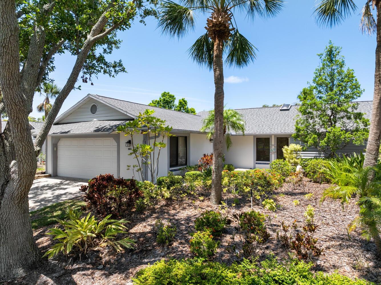 One or more photo(s) has been virtually staged. Discover a rare opportunity to reside in the highly sought-after Portside Villas, nestled within the lush and secure gated community of The Landings. This newly renovated 1,705 square foot home offers a harmonious blend of modern elegance and practical design, perfect for both relaxation and entertaining. This stunning home features 3 spacious bedrooms and 2 fully updated bathrooms, offering both comfort and modern amenities. Designed with an open, flowing layout, the light-filled interior boasts volume ceilings and an expansive living room, perfect for both relaxing and entertaining. The kitchen is a chef’s delight, equipped with 42-inch cabinets with soft closures, Quartz countertops, and brand-new top-of-the-line Thermador stainless steel appliances. Enjoy versatile dining options with a formal dining room, a cozy breakfast area, and a dry bar complete with elegant glass cabinets for stylish storage. The residence boasts thoughtfully designed interiors that prioritize comfort and sophistication. The primary suite is particularly inviting, with ample closet space, an en-suite bathroom and tranquil lake views. The secondary bedrooms offer versatile options for guest accommodations, a home office, or creative spaces. The home’s interior features neutral ceramic tile flooring throughout, fresh paint, and all-new fixtures, creating a pristine and contemporary ambiance while a western wall of windows provides breathtaking and relaxing sunset vistas. Equipped with whole-home hurricane protection, featuring all impact glass windows and doors, this home offers unparalleled security and peace of mind. The spacious 2-car garage adds convenience and storage options. Residents of The Landings enjoy exclusive access to the private Landings Racquet Club, which includes 8 Har-Tru tennis courts and facilities for pickleball, a heated swimming pool for endless relaxation and exercise and fitness center, meeting rooms, and a well-stocked library. In addition, the community offers 24-hour security and a stunning natural environment with access to Sarasota Bay.