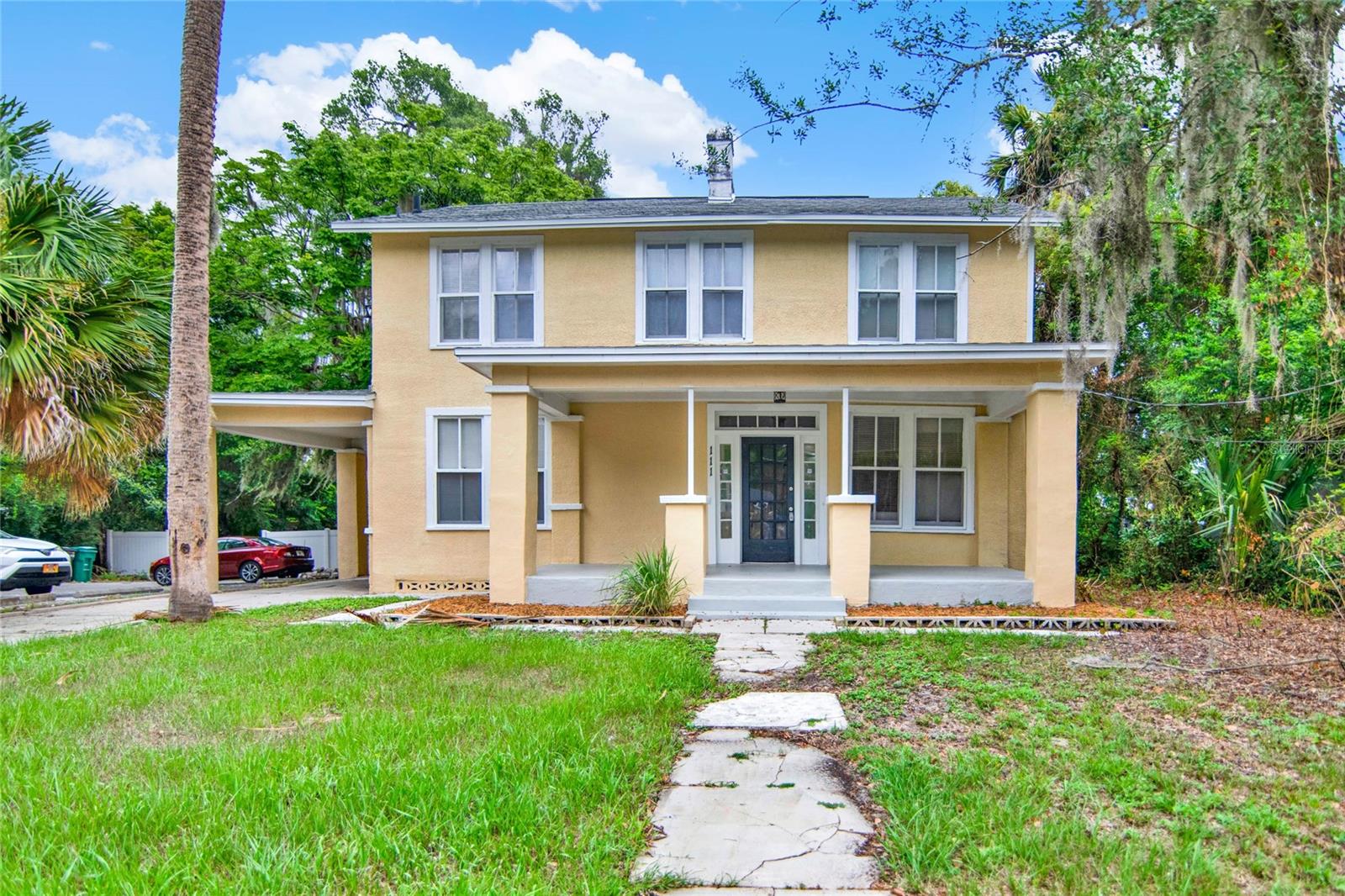 Uncover the potential in this GORGEOUS diamond in the rough! Embrace the charm and character of this beautifully updated early 20th-century home, complete with a new roof installed in 2020 and numerous upgrades throughout. This inviting two-story, 4-bedroom, 2-bathroom residence offers nearly 2,000 square feet of living space, providing ample room to spread out or accommodate a large family. Upon entering the great room, you will find this home features a wood-burning fireplace, perfect for cozying up during the holidays, and real hardwood floors that run throughout the home adding warmth and character. Adjacent to the great room is a second living area and a sitting room featuring tray ceilings, which could easily be transformed into a formal dining space. There are numerous windows that allow for an abundance of natural light, creating a bright and airy atmosphere at each turn. The blend of old-world charm with modern updates makes this home truly unique and full of potential. Step into the updated kitchen, where you'll find elegant granite countertops, recessed lighting, and plenty of counter and cabinet space, ideal for crafting your next recipe and entertaining guests. Just beyond the kitchen, you'll discover a convenient indoor laundry room and a bathroom with a stand-alone walk-in shower. Upstairs, you'll find all four generously sized bedrooms and another bathroom featuring a shower/tub combo. The front porch offers a lovely spot to sit and unwind, enjoying the tranquil surroundings, while the carport provides convenient shelter for your vehicle. Additionally, the small back porch is perfect for easily bringing in groceries and offers a cozy outdoor space to drink your morning coffee. All previous structural issues have been meticulously corrected, yet there are still opportunities for you to add your personal touch and make this home entirely your own. Plus, this charming home is located in a NO HOA neighborhood, offering you more freedom and flexibility! Conveniently located off Highway 44 with easy access to 17-92, this home is situated close to natural springs, parks, and just a short drive from beautiful sandy beaches. With many shopping and dining options nearby, you'll have everything you need within reach. Whether you're looking to make this your permanent residence or a fantastic rental investment, this property checks all the boxes! Don't miss the chance to take advantage of this rare opportunity. Call today to learn more and schedule a private tour!