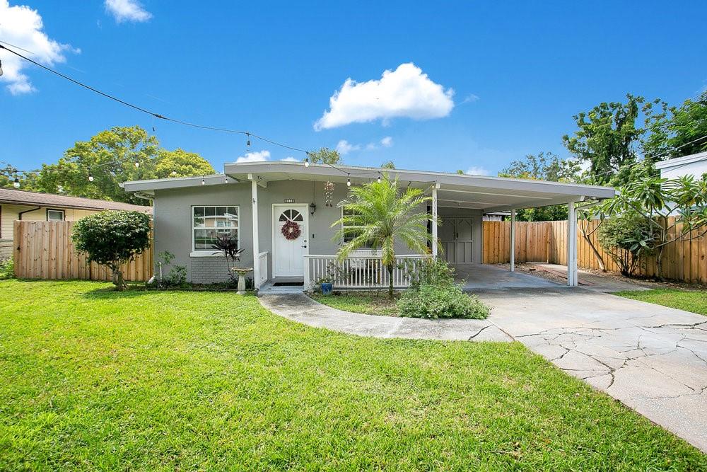 Charming Mid-Century Ranch in Desirable Orlando Neighborhood
This delightful single-story home offers comfortable living with thoughtful updates throughout. The open-concept living and dining area features beautiful tile flooring, modern ceiling fans, and abundant natural light from large windows with stylish bamboo blinds.
The completely renovated kitchen showcases white Shaker-style cabinets, granite countertops, stainless steel appliances including refrigerator and range, and a functional breakfast bar with seating. The kitchen flows seamlessly into the living spaces, making it perfect for entertaining.
The home includes well-appointed bedrooms with ceiling fans and ample natural light. One bedroom features attractive wainscoting and coastal-inspired décor. The full bathroom has been updated with modern fixtures, a granite vanity top, and colorful designer touches.
A true highlight is the expansive covered outdoor entertaining area featuring exposed beam ceilings, string lighting, and ample space for dining and relaxation. The outdoor space includes both covered and open patio areas, perfect for Florida's year-round outdoor lifestyle.
Additional features include a convenient carport, mature landscaping with palm trees, and a private fenced backyard. Don't miss the amazing detached block workshop that could be turned into your own private man-cave or she-shed. The property offers excellent curb appeal with a well-maintained exterior and lush lawn.
Located in a quiet Orlando neighborhood with easy access to local amenities, shopping, and dining. This move-in ready home combines vintage charm with modern conveniences - perfect for first-time buyers or anyone seeking comfortable single-story living.