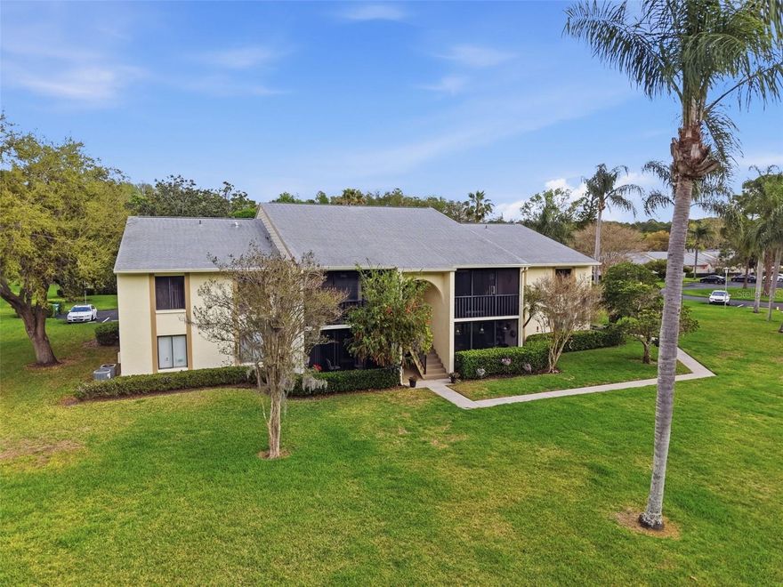 Discover the ease of Florida living in the desirable Deer Hollow community. Located on the second floor, this well-maintained 2 bedroom, 2 bath condominium combines comfort, thoughtful updates, and peaceful natural surroundings. Inside, the home reflects clear pride of ownership with neutral interior paint, updated flooring, updated baseboards, modern lighting and fixtures, and new balcony screening overlooking the pond, creating a clean and inviting space that is ready to enjoy. The spacious primary bedroom features a beautifully updated en-suite bath designed with a frameless glass shower, stylish vanity, updated hardware, and attractive tile flooring. The second bedroom offers flexibility with a built-in Murphy bed, making the space suitable for guests, a home office, or additional living needs. Both bedrooms overlook tranquil pond and preserve views, while the screened private balcony provides a relaxing outdoor space with views of the walking path and water, where local wildlife, including deer, are often seen. Residents of Deer Hollow have access to community amenities that include a clubhouse, heated swimming pool and spa, tennis courts, and a playground. The location offers convenient access to top-rated schools, Downtown Dunedin, the Tarpon Springs Sponge Docks, Gulf Coast beaches, and several beautiful Florida state parks. Carefully maintained and move-in ready, this home offers a comfortable setting with scenic surroundings and convenient access to nearby destinations.