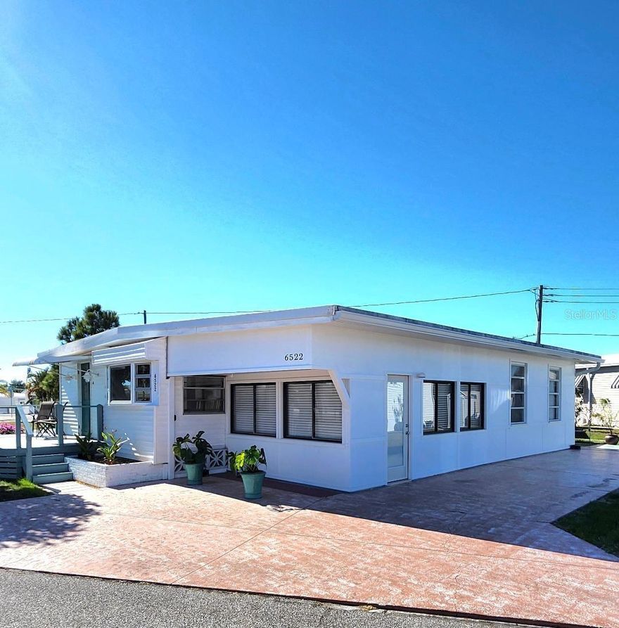 1300 square feet in a Coastal haven! This is a 2 Bedroom, 1 Bath Mobile Home on an oversized Double Corner lot in the highly desired, active 55+ Trailer Estates community. Relax with your morning coffee and a good book on the front porch overlooking a wide green space. Open and spacious Living and Dining area. A light and airy bonus Family/Game Room entertains just off the kitchen. New double glass paneled barn doors separate a huge inside Laundry/Utility multi-use area currently set up for Office, with room for crafts too! Plenty of space to add another Bedroom/Bath or expand. A/C 2016. No lot rent, Park Fees are included into annual real estate taxes. Boaters have direct access to Sarasota Bay from the Marina. Trailer Estates community offers so many options for a great day! Enjoy the large, heated community pool, hot tub, gym and wood shop. The community buzzes with pickleball, shuffleboard, kayaking, horseshoes, bocce, dancing and more. A US Post Office on site. 10 minutes to the SRQ Airport. Convenient to shopping, restaurants, the Arts and everything in Bradenton/Sarasota. Sold furnished. Bring offers!