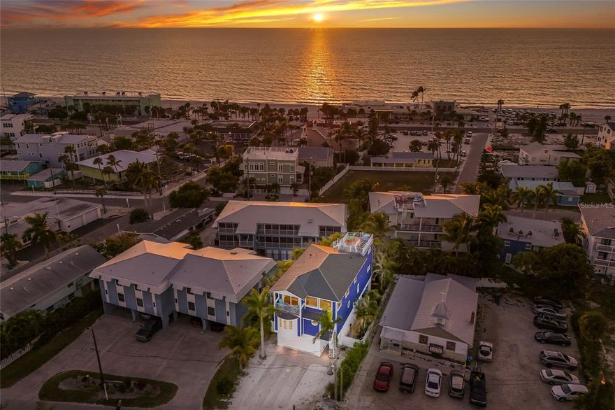 LUXURY COASTAL RETREAT with 360° WATER VIEWS just steps from Bradenton Beach!!! Just two blocks from the sugar sand shores and perfectly centered between the beach and the bay, this spectacular three-story coastal retreat offers breathtaking 360° views of both the Gulf of Mexico and Sarasota Bay. Whether you are searching for a year-round residence, seasonal escape, or high performing investment property, this one-of-a-kind home truly has it all. With 5 bedrooms, 5.5 bathrooms, and multiple indoor and outdoor living spaces, the home is designed for both luxury and comfort. The first level welcomes you with a bright sitting area featuring sliding glass doors overlooking the HEATED pool and spa, along with a separate BONUS room perfect for a home gym, owner’s storage, or beach gear room. On the second floor, you’ll find four spacious bedrooms, each with its own ENSUITE bathroom and walk-in tiled shower, plus an open loft area currently set up with extra beds that can easily become a kids’ play area, game room, or lounge space. The third floor serves as the main living area, showcasing incredible full 360° water views, an open-concept kitchen with a large island and seating, granite countertops, stainless steel appliances, and peek-through windows flanking the stove, a separate dining area for formal or casual entertaining, and a living room surrounded by STUNNING water views. Also on this level is a PRIVATE bedroom suite with balcony access and another ensuite bathroom with dual sinks, and a walk-in tiled shower, PLUS a cozy sitting area leading to a balcony overlooking the pool and a spiral staircase to the ROOFTOP DECK creating your personal PARADISE for sunset watching and stargazing over the Gulf and bay. The outdoor living space offers a beautifully tiled heated pool and spa, a large covered lanai with wood plank ceilings, pavered flooring, a fully FENCED yard, and low-maintenance TURF grass for privacy. The pool features a NEW ELECTRIC HEATER and NEW POOL PUMP, the exterior has been freshly painted, and all appliances are lightly used and in excellent condition. Located just minutes from historic Bridge Street, this home is close to colorful shops, local restaurants, vibrant nightlife, live music, a fishing pier, mini golf, and more, with Bridge Street connecting the Sarasota Bay side to the Gulf of Mexico side of the island. This is the perfect place to unwind after a long day at the beach with endless activities nearby, and it truly doesn’t get better than this...LUXURY, LOCATION, LIFESTYLE, and VIEWS all in one unforgettable coastal property.