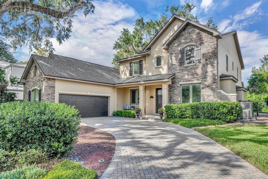 This custom lakefront home on Winter Park's Chain of Lakes offers stunning views of Lake Virginia and is in the historic Virginia Heights neighborhood, just a short walk from Rollins College and downtown Park Avenue. Facing north, it provides picturesque sunrise views over the lake, highlighting Rollins College and its chapel. Lovingly maintained and improved over time, the 4279 square feet does not include an additional 310 square foot finished bonus room with separate HVAC, perfect for game room or office. Upon entering, you are greeted by lake views and a foyer that leads to separate formal living and dining spaces, featuring wood floors, crown molding, plantation shutters, and 10’ ceilings throughout the first floor. The main living space showcases an open-concept kitchen and family room, and flows to the outdoor patio. The spacious kitchen has a gas cooktop, a built-in desk, island seating, an eat-in breakfast space, a walk-in pantry, and a built-in bar with beverage refrigerator. The family room has custom built-ins and a gas fireplace, and overlooks the manicured backyard, pool, and lake. The large downstairs owners’ retreat with picture windows overlooks the lake and a private screened porch with unobstructed views, and the updated bathroom has double vanities and sinks, glass shower, spa tub, and custom walk-in closet. Upstairs there are three bedrooms with attached bathrooms, two bonus spaces, and a media room, offering abundant flex space and storage. Comfort, luxury, and tranquility abound in the backyard with a pool surrounded by paver patio, grassy yard, and boathouse with a lift. The property also includes an oversized two-car garage. Improvements include new roof/2023, whole-house generator/2021, boathouse deck replaced with Trex decking and new roof/2021.