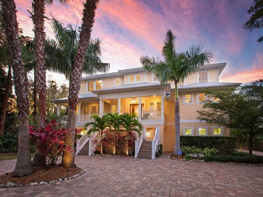 Tucked away on the secluded end of Siesta Dr., coming up to this breath taking home by land or sea will certainly impress the most discriminating buyer.  Situated on a deep water canal, just a stone's throw to the open waters of Sarasota Bay, this Key West style home celebrates the relaxed island lifestyle, yet incorporates a chic urban interior worthy of any sophisticated world traveler.  Luxurious finishes compliment each space with the finest granite, hardwood flooring, custom cabinetry and gourmet kitchen to die for.  The bonus space below offers a gym, art studio, and entertaining space.  State of the art technology, specialized lighting, surround sound, central vac, are just a few of the many amenities this home offers.