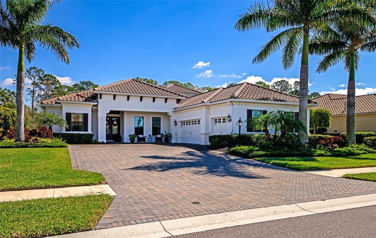 2019 Built, 3827 Sq Ft Block, Tile Roof, IMPACT Windows and Doors Throughout, Natural Gas Generator, Private .46 Acre Lot, Large Screened Lanai, Custom Heated Pool, 3 Fire Features, Outdoor Kitchen + Dining. 4BD, 4BA, LR w Fireplace, DR, Bonus Room, Office. Kitchen Island w/veg sink, Natural Gas Appliances, 3 Car Garage, Large pavered driveway, Furniture Package. Welcome to your luxury home retreat within the exclusive and highly sought-after Wildgrass community, offering an exceptionally private residential setting. This exquisite residence featuring 4 bedrooms, 4 baths, a club room and an office, was custom crafted on an expanded footprint with raised ceilings in 2019, boasting mature landscaping with majestic Royal Palms. It sits on a .46 acre lot, with a generous driveway providing ample space for grand entertaining.
Inside, a beautifully seamless open floor plan awaits with engineered hardwood flooring gracing the main level and posh Shaw carpet adorning the second level, offering both elegance and comfort underfoot. Abundant natural light filters through impact windows and doors, creating an inviting ambiance of warmth and tranquility, ideal for relaxation and entertainment throughout the day.
The fully equipped kitchen features a spacious island with a vegetable sink, high-quality appliances, and reverse osmosis water filtration, ensuring meal prep is a delight. Enjoy peace of mind in your home with a whole-house generator and revel in the comfort of voluminous tray ceilings adorned with gorgeous light fixtures throughout. Entertain in the clubroom with custom windows, unwind in the freestanding tub of the spa-like primary suite, or cozy up by one of the gas fireplaces on cooler evenings.
The luxury doesn't stop indoors. Step into the exceptional outdoor living space, where the exterior transcends expectations with an expansive lanai that beckons you to indulge in the beautiful weather. Here, a spectacular pool awaits, providing the perfect setting for a lively game of volleyball or a refreshing swim. Adjacent to the pool, discover the fully equipped outdoor kitchen and dining area, inviting you to indulge al fresco while enjoying the balmy breezes and lush surroundings. The ambiance is further enhanced by three fire features. Whether hosting a casual barbecue with friends or enjoying a quiet dinner under the stars, this outdoor oasis offers the perfect setting to make lasting memories and savor the beauty of the Suncoast.
Discover the convenience of your new home, nestled in an A-rated school district, mere minutes from UTC's shopping and dining, while also offering easy access to the pristine shores of Siesta Key Beach and the vibrant energy of Downtown Sarasota. With its luxurious amenities, elegant design, and unparalleled outdoor living spaces, this residence offers an exceptional opportunity to experience the best of the Suncoast and Florida living at its finest. Bedroom Closet Type: Walk-in Closet (Primary Bedroom).