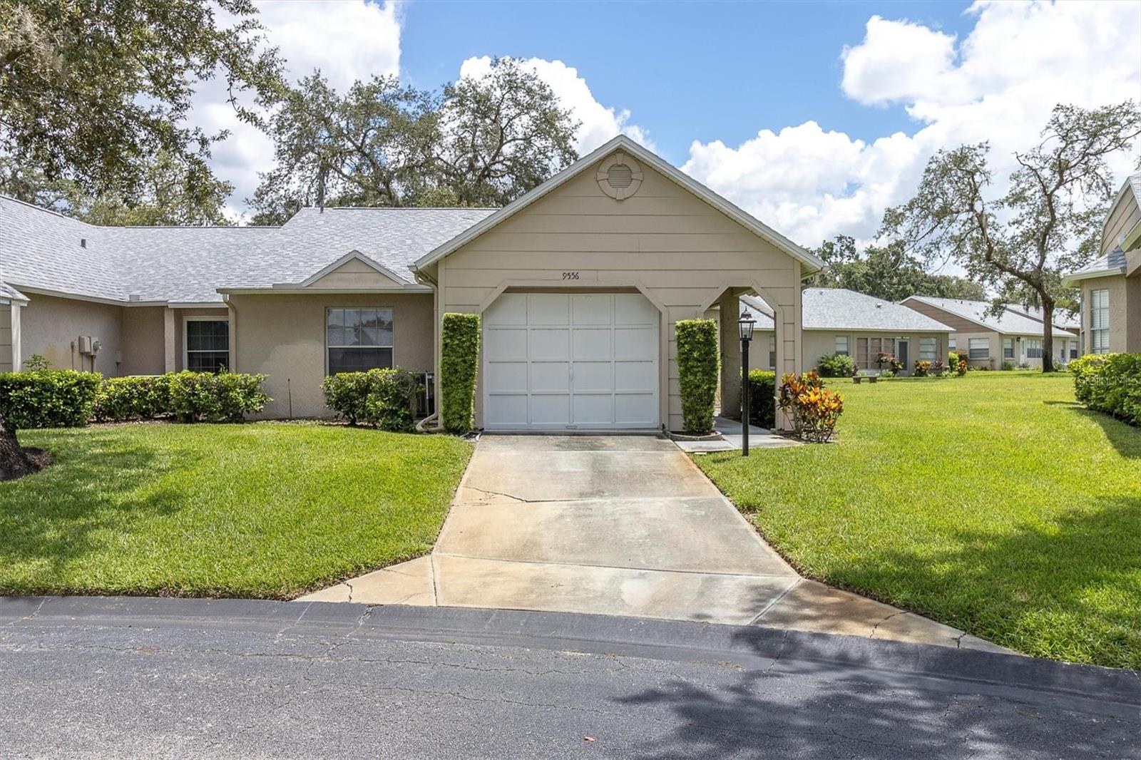 THIS IS SUCH A SWEET BARGAIN BEAUTY! 2/2/1 CONDO IDEALLY LOCATED IN ONE OF TRINITY'S MOST POPULAR OVER 55 COMMUNITIES! NICE GREEN VIEWS FROM MOST ROOMS! LOVE THE BIG GREAT ROOM STYLE FLOOR PLAN! BOTH BEDROOMS ARE A GENEROUS SIZE BOTH FEATURE WALK IN CLOSETS! THE PRIMARY BEDROOM HAS A PRIVATE BATH WITH STEP IN SHOWER! THE DINING AREA IS SURROUNDED BY WINDOWS. THE BRIGHT KITCHEN HAS TONS OF CABINETS & "MILES" OF COUNTER TOP WORK SPACE! IT IS COMPLETED BY GORGEOUS APPLIANCES! YOU'LL LOVE THE PASS THROUGH COUNTER BAR THAT OPENS TO THE GREAT ROOM, PERFECT WHEN ENTERTAINING! CARPET, CERAMIC & LAMINATE IN ALL THE RIGHT PLACES. NEWER WASHER & DRYER. TAKE A SHORT STROLL DOWN WINDING TREE LINED STREETS DOTTED BY SERENE PONDS TO THE ACTIVE CLUBHOUSE FEATURING MORE ACTIVITIES THAN YOU WILL BE ABLE TO KEEP UP WITH! HEATED POOL AND SPA, TENNIS CTS, PICKLEBALL, BOCCE, EXERCISE CLASSES, POOL & BILLIARD ROOM, LIBRARY, CRAFTS, DANCES, PARTIES, BBQ'S THE LIST IS ENDLESS! ALL THIS PLUS THE AMENITIES THE TRINITY AREA OFFERS MAKES IT AN AMAZING OFFERING! HURRY TO THIS ONE! HESITATE...AND YOU'LL BE TOO LATE INTERIOR PHOTOS COMING SOON
