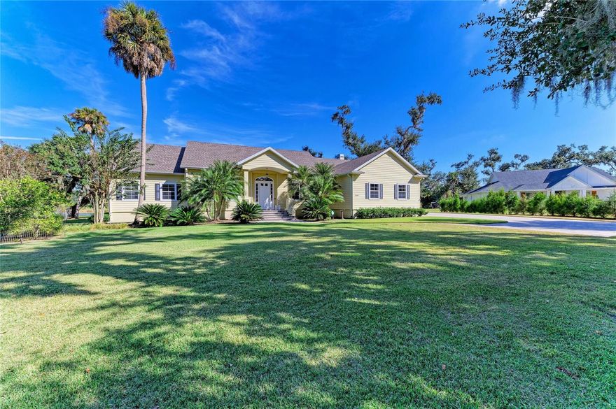 This home sits on one of the nicest lots in Oak Ford, and has been thoughtfully designed and lovingly maintained by its original owners.  Nestled among live oaks and native palms, this custom home blends luxury with Old Florida charm.  The home is at the end of a cul-de-sac, offering privacy on just under an acre of land. Step inside this impeccably crafted home to soaring 10- to 14-foot ceilings that create an airy, open feel. The open-concept layout seamlessly integrates the kitchen, dining area, family room, and living room, all offering breathtaking views of your private oasis. With rich luxury wood flooring throughout the main living areas, custom-built features, and a wood-burning fireplace, this home exudes warmth and sophistication. The gourmet kitchen features a custom tile backsplash, solid wood cabinetry and stainless-steel appliances including a Wolf cooktop, Thermador double ovens and Bosch dishwasher. The home features three bedrooms, with the possibility of a fourth bedroom currently set up as a home office. The dedicated home office is complete with double French doors and a closet, offering versatility as a home workspace or flex room to suit your needs. The master bedroom boasts stunning lake views and an oversized walk-in closet. The oversized garage provides ample space for two vehicles, a golf cart, and all your recreational gear. Step outside to enjoy your morning coffee or unwind with a glass of wine as you take in the sunset over the shimmering lake. Watch as deer and native wildlife gracefully roam the property, adding to the serene natural surroundings. This home is equipped with a Central vacuum system, Hard wired security system set up for professional monitoring, a new roof in 2023 (transferrable warranty), new water heater in 2024, impact resistant windows and Kevlar screens for the doors. With low HOA fees and no CDD fees, Oak Ford offers luxury living in a peaceful, picturesque setting while remaining just close enough to the premier amenities of Lakewood Ranch and Sarasota. Call today to schedule your private showing.