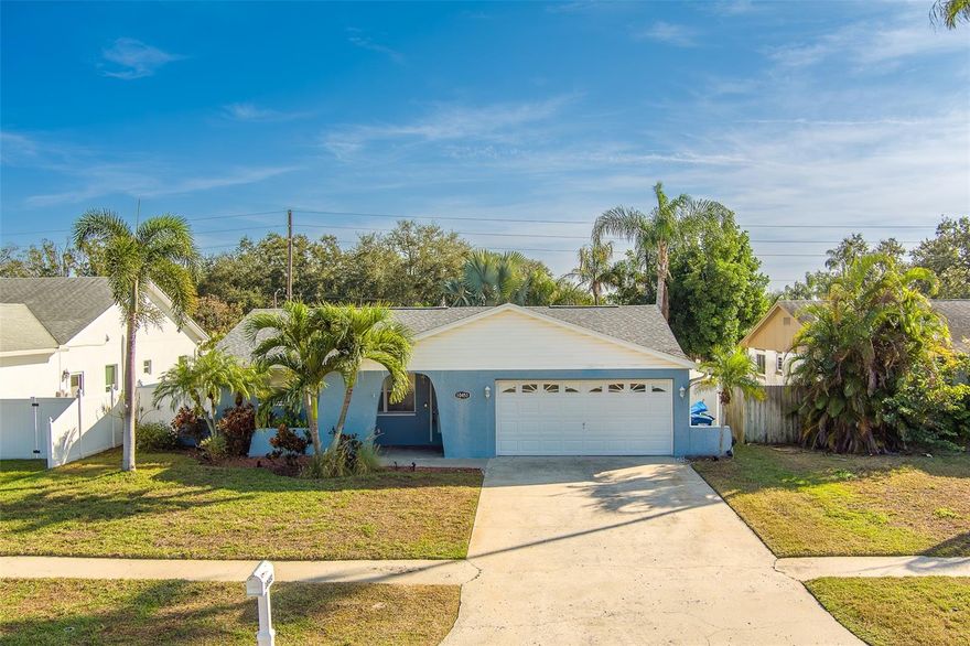 Don't miss this one! 3 Bedroom, 2 Bath, 2 Car garage in a great family neighborhood. Split Plan home. Updated flooring throughout, stainless steel appliances, ice cold 20 Seer A/C from 2017, smart thermostat, large screened in back porch. With multiple beautiful Gulf Beaches less than 15 minutes away and a private, fenced-in backyard, encompassed with beautiful palms and landscaping, this property is perfect for a family. Approximately 4 miles to some of the best public & private schools in the area, grocery stores, Seminole Mall shopping, restaurants, and all your essentials less than 1 mile away. Right next to the Pinellas trail and Walsingham Park access on the same street. Non evacuation zone.