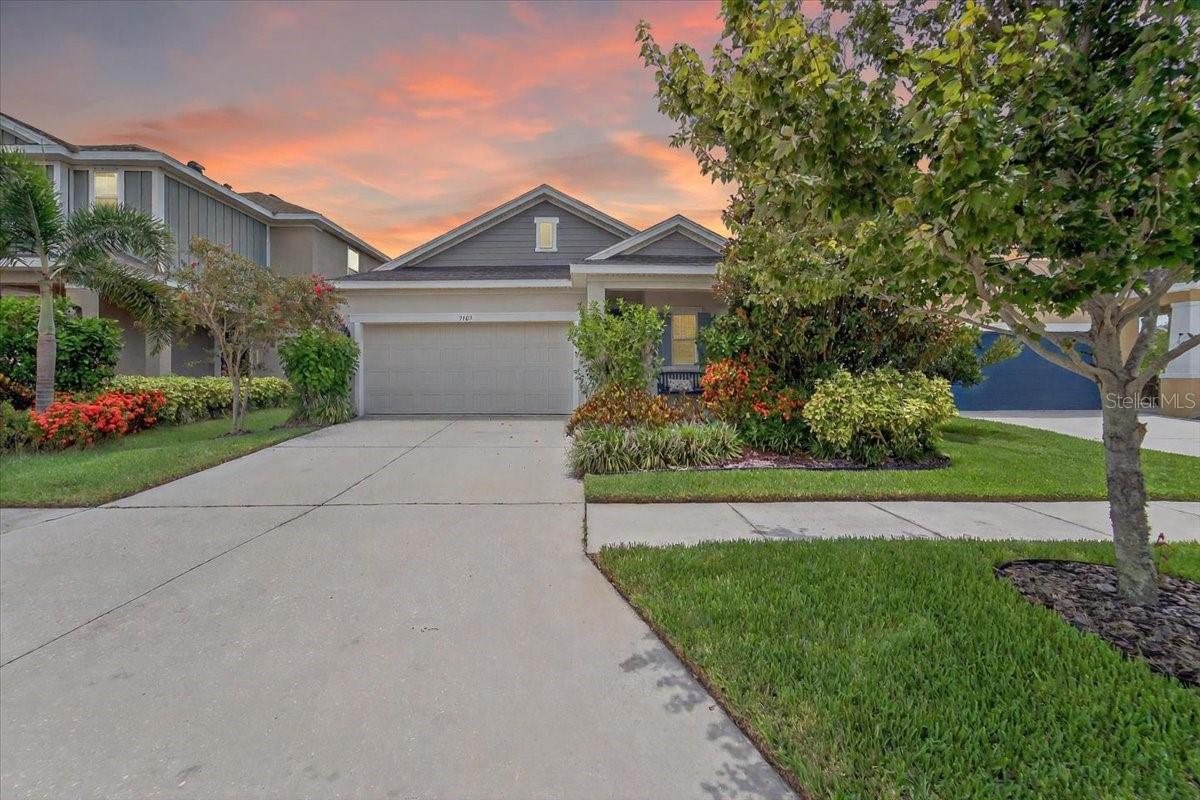 Experience refined Florida living in this beautifully maintained one-story home offering 3 bedrooms, 2 bathrooms, and 1,747 sq ft of thoughtfully designed space. Located in the highly desirable Waterset community, this home blends style, comfort, and functionality in every detail.
From the welcoming front porch to the screened lanai out back, every inch has been carefully curated, and within walking distance to the pool and amenities!. Step inside to soaring 9-foot ceilings, recessed lighting, and an open, light-filled layout ideal for entertaining. The chef-inspired kitchen is the true centerpiece—featuring Alpine white 42” cabinets, stunning white quartz countertops, a large slate-gray island with built-in cabinetry, and top-tier stainless steel KitchenAid and Whirlpool appliances, including a gas cooktop, built-in oven, and microwave.
The spacious dining area is drenched in natural light from surrounding windows, while the living room seamlessly connects to the screened lanai with ceiling fan—perfect for indoor-outdoor enjoyment.
The serene primary suite showcases rich wood tile flooring and a custom walk-in closet with built-in drawers, shoe racks, and shelving. The spa-like ensuite bath boasts a double granite vanity, walk-in shower, and tasteful ceramic tile.
Two guest bedrooms with plush carpeting share a stylish full bath with slate gray cabinetry and tile flooring. Additional features include a separate laundry room with window, wood laminate flooring in all main living spaces, and a 2-car garage equipped with built-in storage racks.
Enjoy added value and peace of mind with a transferable extended builder’s warranty.
Live the lifestyle you’ve been dreaming of with access to Waterset’s exceptional amenities—resort-style pools, fitness centers, playgrounds, trails, dog parks, and community events. This is more than a home—it’s a lifestyle.