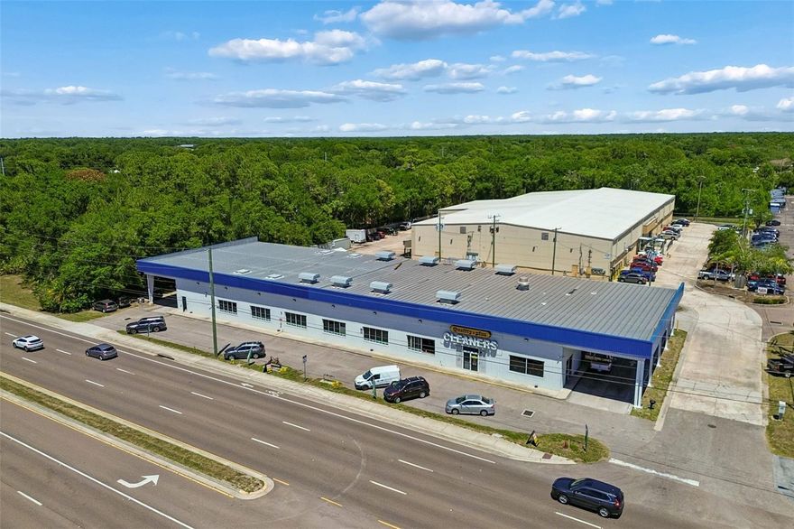 We are proud to present for sale 9945 Racetrack Road (the “Property”), a rare owner-user industrial/flex opportunity located along highly traveled Racetrack Road in the Westchase / Oldsmar submarket. The Property consists of approximately ±15,844 SF situated on ±45,738 SF of land with over ±240 feet of direct frontage and traffic counts exceeding ±19,200 AADT. Constructed in 2000, the building features metal frame construction with a steel frame metal roof system and offers a highly functional combination of warehouse, showroom, office, and covered loading areas. The Property is currently owner-occupied by Quality Plus Cleaners and will be delivered vacant at closing, making it ideal for an owner-user seeking immediate occupancy. The layout includes approximately ±13,364 SF of warehouse and operational space featuring approximately 16’ clear to beam and approximately 18’ to 21’ clear to ceiling. Loading capabilities include two (2) 8’ x 8’ receiving doors, one (1) 12’ x 12’ overhead door, six (6) oversized 12’ x 16’ grade-level overhead doors, and three (3) 7’ x 14’ receiving doors. The Property also features two covered drive-through loading/carport areas with canopy heights reaching approximately 20’. The building is serviced by 480-volt three-phase power with multiple electrical panels designed for high-output industrial operations. The front portion of the building features approximately ±1,570 SF of showroom/display area with attached office space, along with approximately ±964 SF of second-floor mezzanine-style office overlooking the warehouse area. Strategically positioned with excellent visibility, signage exposure, and access to Tampa Road, Hillsborough Avenue, and the Veterans Expressway, the Property offers a unique combination of industrial utility and commercial frontage rarely available in today’s Tampa Bay industrial market.