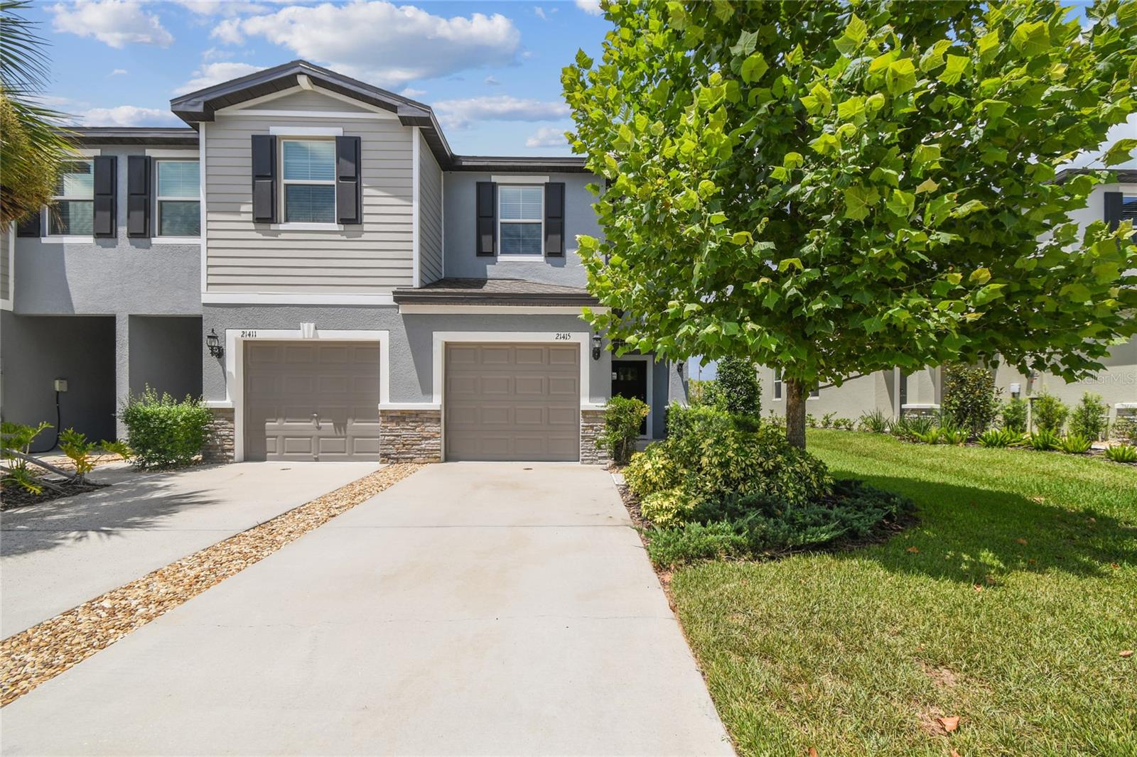 FORMER BUILDER MODEL – NEVER LIVED IN – END UNIT townhome located in the master-planned community of THE TOWNES AT LAKE THOMAS. Built in 2023, this beautifully finished home features 2 BEDROOMS, 2.5 BATHS, and a 1-CAR GARAGE. The light-filled first floor offers an OPEN-CONCEPT layout with GRANITE COUNTERTOPS, WHITE CABINETRY, STAINLESS STEEL APPLIANCES, and ample room for dining. A SLIDING GLASS DOOR leads to the BACK PATIO, perfect for outdoor enjoyment. A convenient HALF BATH completes the main level. Upstairs, the SPACIOUS PRIMARY SUITE includes DUAL VANITIES and a WALK-IN SHOWER with classic SUBWAY TILE. The second bedroom with private ensuite full bath, and upstairs LAUNDRY ROOM complete the upper level. Community amenities include a PARK, POOL, and CABANAS. Ideally located near TAMPA PREMIUM OUTLETS, ADVENTHEALTH CONNERTON, and the LAND O’ LAKES RECREATION COMPLEX. LOW-MAINTENANCE LIVING with NO CDD FEES in a sought-after location!