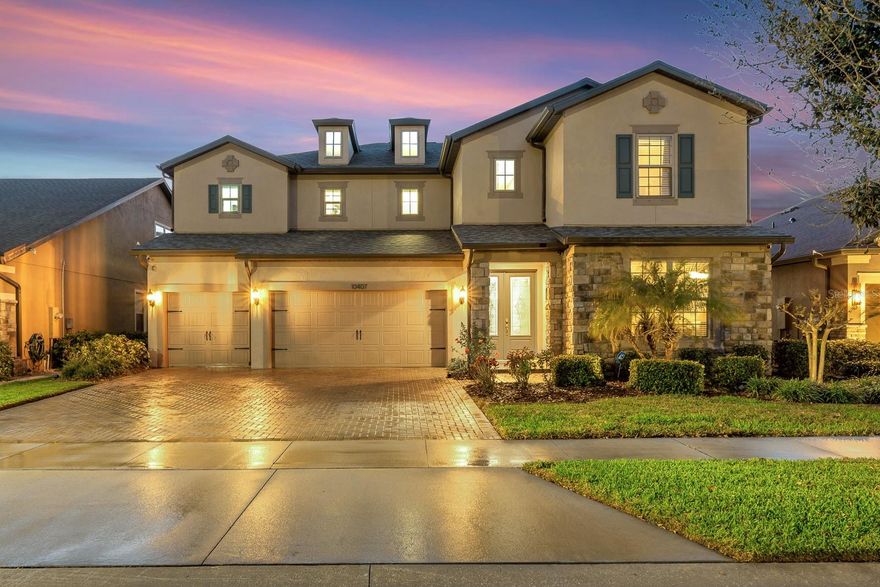 Welcome to this spacious and beautifully appointed home located in the gated community of Starling Oaks in Riverview, FL. Offering 4,596 square feet of living space, this 4-bedroom, 4-bathroom home with a 3-car garage combines thoughtful design, modern updates, and exceptional indoor-outdoor living. Arrive to impressive curb appeal with a brick-paved driveway and front entry leading to grand double doors. Inside, a soaring two-story foyer sets the tone, flanked by formal living and dining rooms. The first floor features 21” ceramic tile throughout the main living areas, bathrooms, and laundry room, along with 9’ ceilings that enhance the open feel. The heart of the home is the expansive great room, where the family room, kitchen, and dinette seamlessly connect. The family room is pre-wired for a surround sound system featuring Klipsch speakers and opens to the outdoors through pocketing triple sliding doors. Step outside to your private retreat—complete with a large screened pool enclosure, travertine paver deck, covered lanai for shaded seating, nice west view to enjoy sunsets every day with a backyard facing a large conservation area.  The fully equipped outdoor kitchen includes a refrigerator, sink, and storage drawers. The large pool is heated with solar panels replaced in March 2025. The kitchen is designed for both everyday living and entertaining, featuring 42” designer cabinetry, stone countertops, stainless steel appliances including a wall oven and microwave, cooktop with vent hood, side-by-side refrigerator, and dishwasher. A large island with extra cabinets provides more space for storage. A convenient wet bar with wine refrigerator and sink is located between the kitchen and formal dining room, across from a walk-in pantry. Also on the first floor is a spacious entry from the garage with a large storage closet, a media room currently used as a 5th bedroom, and a full bathroom with direct access to the pool area. Upstairs, engineered hardwood flooring (installed May 2024) continues through a versatile loft area, the primary suite, and three secondary bedrooms. The laundry room is also located on the second floor and includes cabinetry, a utility sink, and generous counter space. The primary suite spans one entire side of the home and includes a private sitting area ideal for a home office, fitness space, or lounge. The en-suite bathroom offers dual split, comfort-height vanities, a soaking tub, a separate shower with dual shower heads, private water closet, and two walk-in closets. Bedrooms 2 and 3 share a Jack and Jill bathroom and each feature walk-in closets, while Bedroom 4 includes its own en-suite bath and walk-in closet. Additional highlights include pre-wired for ethernet and exterior security cameras, exterior paint completed in June 2023, roof replaced in March 2025, and hot water heater replaced in April 2023. Located in a small community with sidewalks and street lighting, this home offers a more private, low traffic setting with low HOA fees and no CDD. Convenient access to US 301, I-75 and the Selmon Expressway makes commuting a breeze, and the property is zoned for highly rated schools.