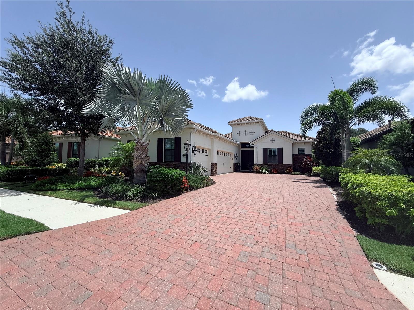 Significant Price Improvement! Bring All Offers!
Now is the perfect time to experience refined living in the Country Club East community of Lakewood Ranch.
Step into a sprawling open-concept layout where the gourmet kitchen seamlessly connects with the great room and dining area—ideal for entertaining or everyday living. The kitchen is a chef’s dream, complete with GE Café appliances, a custom range hood, built-in pot filler, and a striking granite island that comfortably seats five to six. A showstopping 72x72 picture window floods the space with natural light, while a built-in upholstered cabinet bench offers serene views of the pool, spa, and lush golf course beyond.
The luxurious primary suite is a retreat of its own, featuring direct access to the pool and lanai, oversized windows, and a spa-inspired en-suite bath. Enjoy a designer freestanding tub elegantly placed within a glass-enclosed rain shower, dual sinks, and a built-in makeup vanity.
Additional features include a three-car garage with slop sink, pull-down attic access, and finished flooring for extra storage. The extended laundry/craft room is ideal for hobbies or organization, enhanced by a custom pegboard.
The expansive screened lanai is perfect for entertaining, with a heated pool and spa accented by a waterfall. The fully equipped outdoor kitchen includes a built-in grill, hood, sink, and refrigerator—all topped with granite counters.
Each of the three spacious bedrooms has its own en-suite bath, offering comfort and privacy for family and guests. A versatile flex room can serve as a fourth bedroom, home office, or guest suite.
Set within a secure, gated neighborhood, residents enjoy resort-style amenities including pools, state-of-the-art fitness centers, and optional memberships for golf, tennis, and more.
This is more than a home—it’s a lifestyle in one of Florida’s most sought-after communities. Don’t miss your opportunity to make this exquisite property yours.