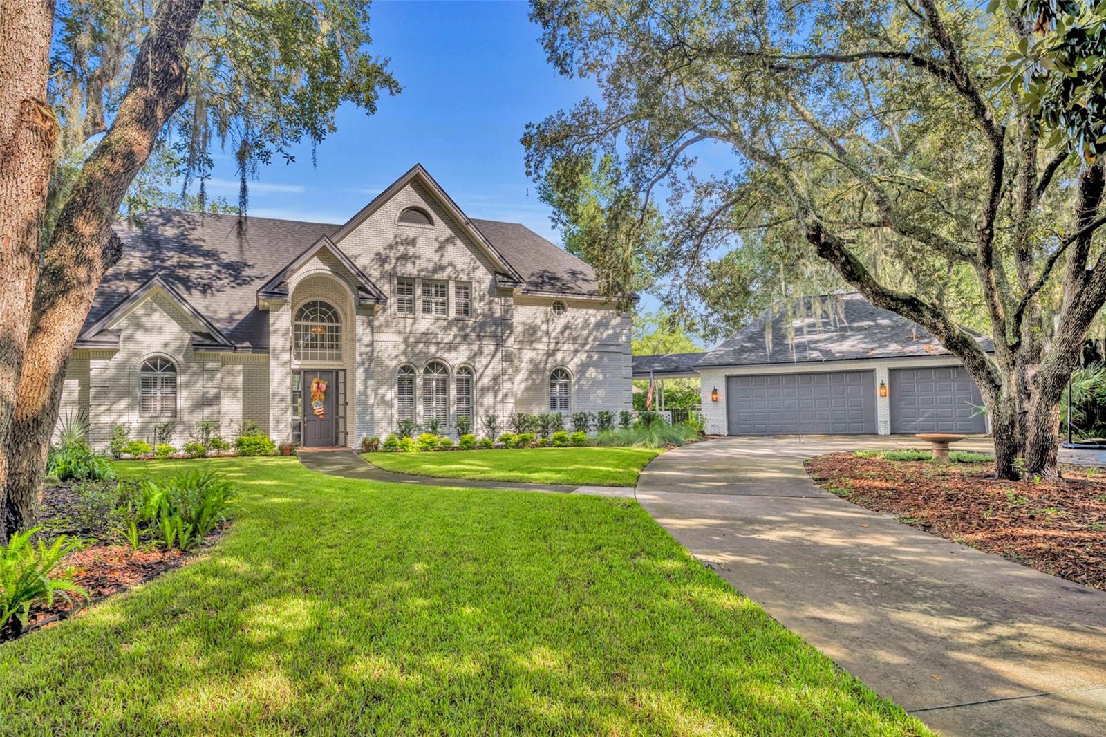 This custom brick home in Huntington is a rare find with a DETACHED 3-CAR GARAGE, with a POOL+SPA on a CUL-DA-SAC. The oversized garage has an unfinished upstairs apartment, and a workshop to die for! The home features wood floors throughout, a spiral staircase and a pool area perfect for entertaining. As you enter the driveway, you'll notice the tropical oasis that awaits you. Low maintenance yard with tons of shade creates privacy and tranquility. Through the front door you are greeted by the soaring ceilings in the rotunda, with views to the pool and formal areas. You'll find the owner's retreat and a guest suite on the first floor, situated away from the family gathering areas for privacy. The grand kitchen has counter space and cabinets for days, along with large island, upgraded appliances, granite counter tops, over-sized dinette area and access to the covered walkway to the detached garage. Attached to the kitchen is the enormous laundry room, along with custom food pantry and secondary set of stairs to the upstairs retreat. On those cool nights you'll appreciate the double-sided fireplace in the formal living and adjoining family room. Plus, you can experience the private fireplace in the master bedroom for romantic evenings. All bedrooms in this home have attached bathrooms, making each room its own private suite. Upstairs is a large loft area with built in bookshelves and enough space to have a pool table. My favorite details are the custom features in every area of this house, from built-in bookcases & china cabinets, a Juliet balcony to a spiral staircase, the pool's rock waterfall, and even walk-in attic access from the bedroom upstairs. There literally is too much to mention on this home, so you need to come see it in person. If you love living in Florida, then this house is for you- tons of outside living space located in the sought after Huntington community!