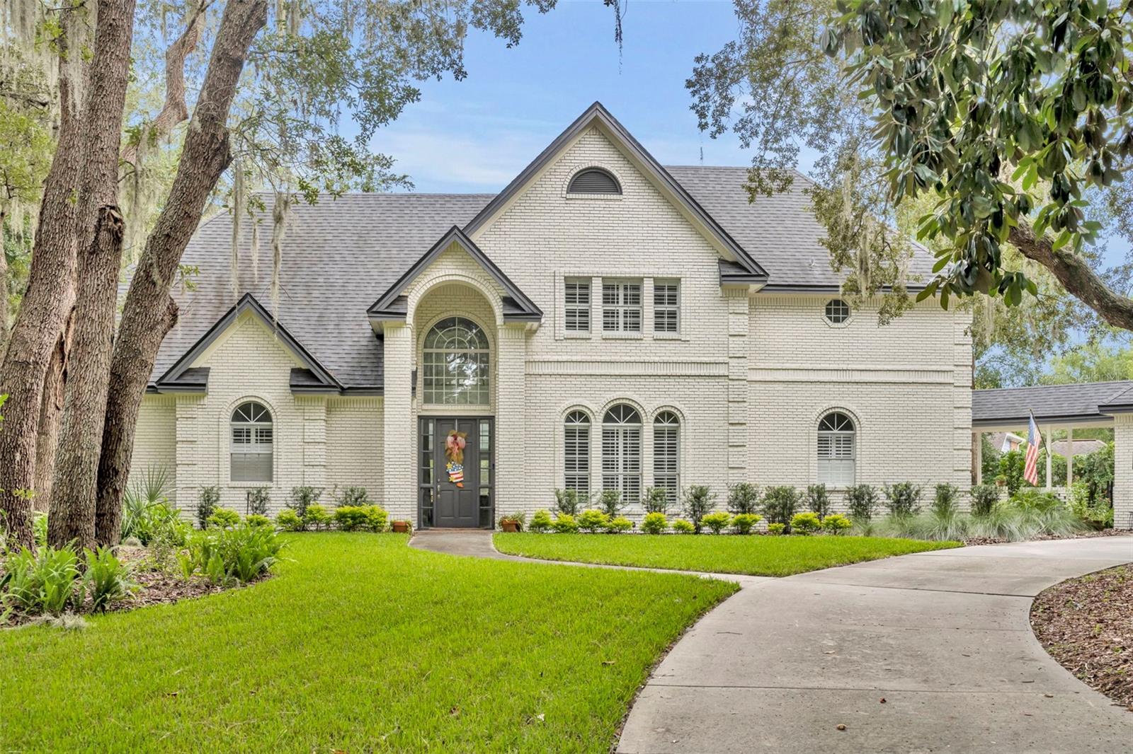 This custom brick home in Huntington is a rare find with a DETACHED 3-CAR GARAGE, with a POOL+SPA on a CUL-DA-SAC. The oversized garage has an unfinished upstairs apartment, and a workshop to die for! The home features wood floors throughout, a spiral staircase and a pool area perfect for entertaining. As you enter the driveway, you'll notice the tropical oasis that awaits you. Low maintenance yard with tons of shade creates privacy and tranquility. Through the front door you are greeted by the soaring ceilings in the rotunda, with views to the pool and formal areas. You'll find the owner's retreat and a guest suite on the first floor, situated away from the family gathering areas for privacy. The grand kitchen has counter space and cabinets for days, along with large island, upgraded appliances, granite counter tops, over-sized dinette area and access to the covered walkway to the detached garage. Attached to the kitchen is the enormous laundry room, along with custom food pantry and secondary set of stairs to the upstairs retreat. On those cool nights you'll appreciate the double-sided fireplace in the formal living and adjoining family room. Plus, you can experience the private fireplace in the master bedroom for romantic evenings. All bedrooms in this home have attached bathrooms, making each room its own private suite. Upstairs is a large loft area with built in bookshelves and enough space to have a pool table. My favorite details are the custom features in every area of this house, from built-in bookcases & china cabinets, a Juliet balcony to a spiral staircase, the pool's rock waterfall, and even walk-in attic access from the bedroom upstairs. There literally is too much to mention on this home, so you need to come see it in person. If you love living in Florida, then this house is for you- tons of outside living space located in the sought after Huntington community!