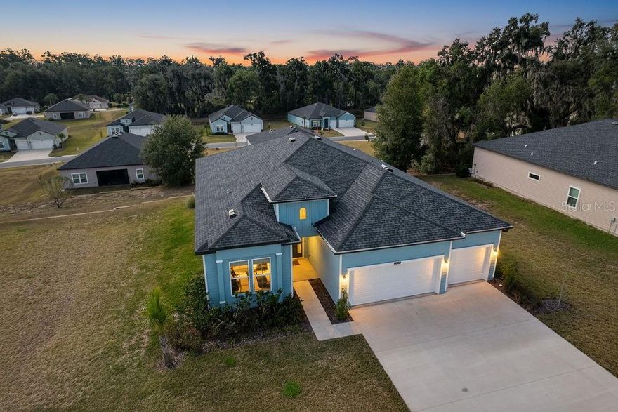 Come inside and be taken aback with an expansive open concept waiting for your personal touches. Designed with you in mind, you will appreciate the oversized rooms, tray ceilings, recessed lighting and a triple-split bedroom design with 4 bedrooms in 3 separate directions.  This home is well-equipped to handle privacy for smaller families or the demanding needs of multiple siblings or overnight guests. Aspiring chefs will appreciate the extended counter space and kitchen design. The 3-car garage with storage and space to accommodate tools, lawn maintenance equipment, bicycles and vehicles will be enough to satisfy craftsmen, gardeners, and outside enthusiasts. Relax in the covered, screened lanai overlooking mature trees and a manicured, irrigated lawn. The large primary bedroom includes a large walk-in closet and bath with oversized shower, as well as a private entry onto the lanai.  Community amenities include private beach access to the crystal-clear Rainbow River, as well as a private clubhouse with lending library, game room, billiards, oversized pool, fitness center, tennis, pickleball, basketball courts and Cheers Restaurant. Residents enjoy a quiet, friendly neighborhood atmosphere with convenient access to shops, dining, and essential services in Dunnellon. Come see all this property has to offer.