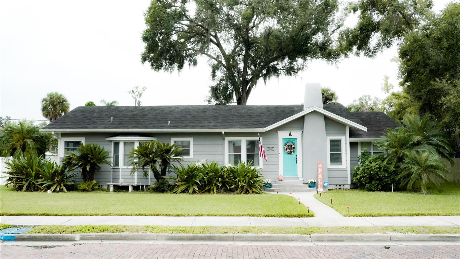 Come check out this beautiful 5 bedroom, 3 bath home in Historic downtown Plant City. Built in 1925 this home has preserved many of its unique character. Entering through the side door into the laundry room will take you into the BIG KITCHEN which features an ISLAND, wooden counter tops, STAINLESS STEEL APPLIANCES, decorative back splash, recess lighting and a timeless window seat. The kitchen and laundry room have tiled flooring whilst the majority of the home has kept its beautiful ORIGINAL WOOD FLOORS. The kitchen connects you to the formal dining room, and french doors lead from the dining area into the living room. The Primary bedroom has a step down into a BIG DRESSING AREA, with a WALK IN CLOSET and a side door leading outside. The HUGE PRIMARY BATHROOM features a DOUBLE VANITY, separate SHOWER STALL and a garden tub. The Living room has beautiful original hard wood flooring, fireplace, crown molding and a bar in the corner, perfect for entertaining or unwinding. Featuring a spacious guest room off of the living room. At the other end of the living area, you will find a huge mud room, leading to a hallway with two more guest bedrooms and a guest bath which has double vanity, tub/shower combo and paneled walls. The office has a closet so this could stay as an office or be used as a 5th bedroom, making the 3rd bathroom ideal for guests. All of the rooms have ceiling fans, crown molding, wood blinds, ORIGINAL WOOD FLOORING, and big baseboards throughout. Step outside and you will find a wooden deck and grill for entertaining and BIG FENCED BACK YARD. Including a NEW VINYL FENCE in front. There is a parking pad on the side of the home. A DETACHED TWO CAR GARAGE with WORKSHOP. The home has an ADT security system that will stay with the sale and the TV in the kitchen stays. AC unit is 2022 and has just been serviced. KITCHEN FRIDGE NOT INCLUDED IN SALE.