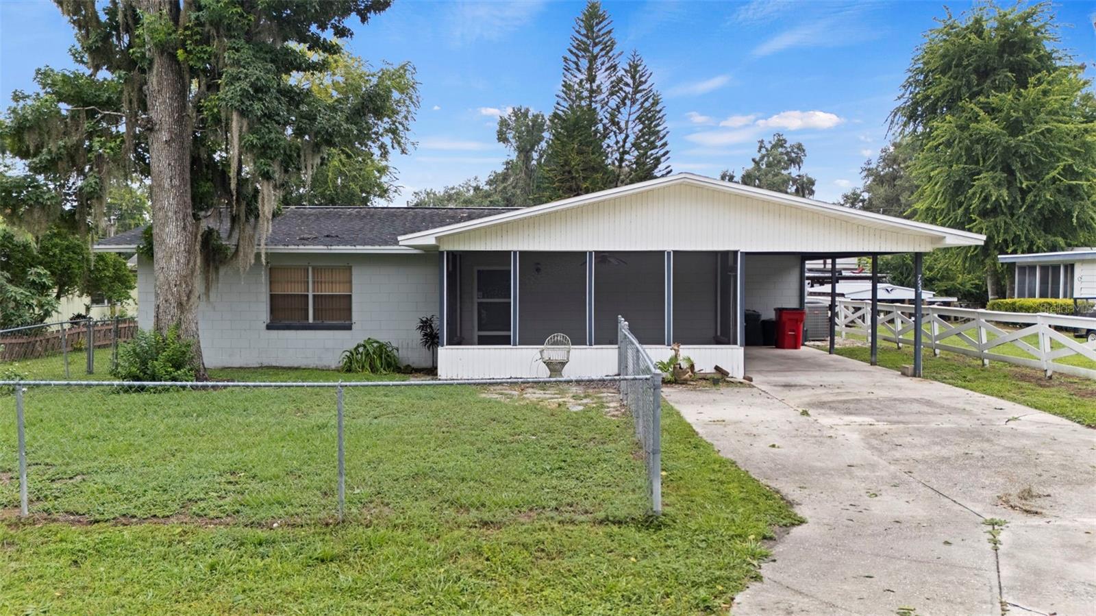 For the buyer who wishes to “get away from it all” an exciting opportunity exists between Tampa and Ocala in Sumpter County on Lake Panasoffkee, just off I-75.
This 2 bedroom, 2.5 bathroom concrete block home sits approximately100 yards by canal to the open, fresh waters of this large lake renowned for its fishing. The covered boat dock on the canal behind the home is ideal for a pontoon or fishing boat.
The home sits on a large lot with plenty of room at the side to store a boat and trailer, or a motorhome. The detached garage in the rear is ideal for a workshop or additional storage. The attached utility room sits just behind the large covered and concrete floored carport and has indoor hookups for a washer/drier, a propane water heater and a half bath.
The front yard is fenced-in and the large screened-in porch offers shade year-round. The kitchen and second bathroom will require some attention but both present projects that any handyman might like to handle.
Nearby attractions include one hour airboat rides at “Tom and Jerry’s Airboat Tours”, or within a short boat ride from home, dock your boat at the “Big Bass Lakefront Resort” and enjoy great food and live music on weekends.
Whether already retired or just looking for weekends of tranquility, this home provides a sanctuary from the fast pace of city life. If this sounds like your kind of getaway, give us a call to arrange a personal showing.