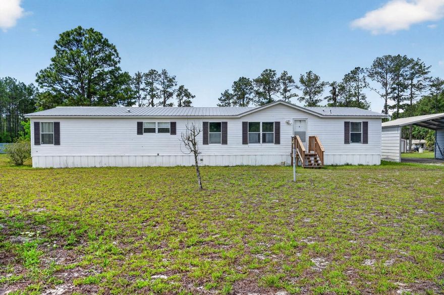 Welcome to your own slice of country paradise at 101 Coleman Place in Satsuma! Situated on a spacious 1.37-acre corner lot with room to roam, this beautifully maintained 4-bedroom, 3-bath manufactured home offers the peaceful lifestyle you’ve been searching for.

Inside, you’ll love the open-concept layout featuring a large living room, oversized dining area, and a spacious kitchen complete with stainless steel appliances, abundant cabinetry, center island, and breakfast bar seating. The split floor plan provides privacy for the primary suite, which includes an updated bathroom with dual vanities and a walk-in shower. A bonus room off the primary suite makes the perfect office, nursery, or flex space.

Step outside and enjoy Florida living year-round from the expansive covered and screened back deck overlooking the above-ground pool and private backyard setting, perfect for entertaining or relaxing evenings. The property also features multiple storage sheds/workshops, plenty of parking space for boats, RVs, and toys, plus a water filtration system already in place.

With a metal roof, generous room sizes, and 1.37 acres of land to enjoy, this property combines comfort, functionality, and privacy while still being conveniently located near the St. Johns River, Palatka, and outdoor recreation.

If you’ve been looking for affordable country living with space inside and out, this one is a must-see!