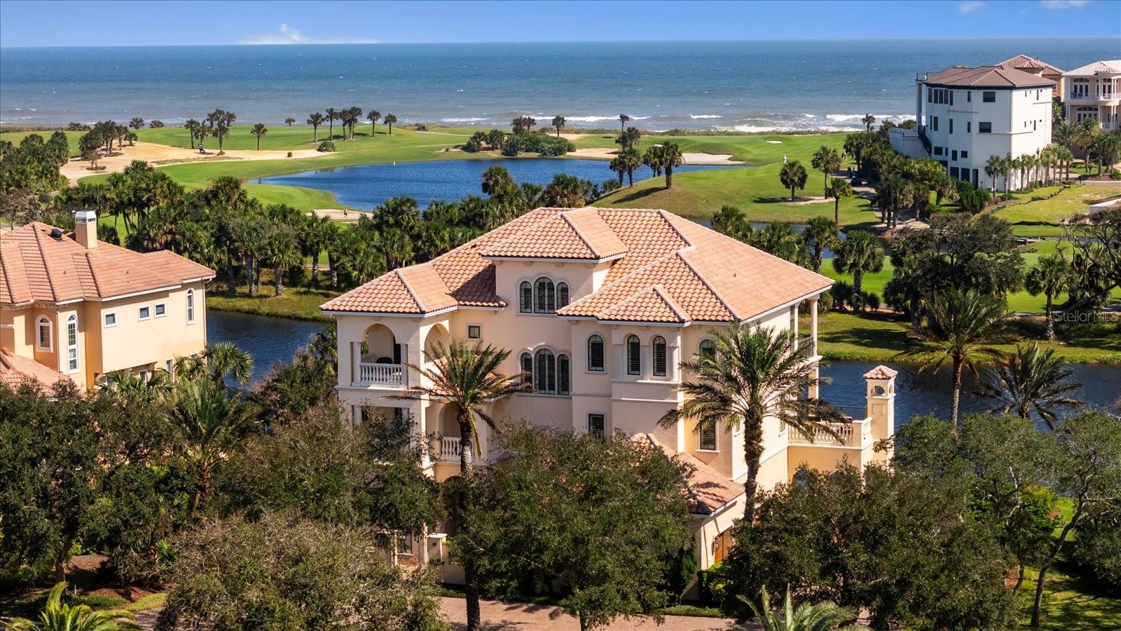 A rare opportunity to own a coastal legacy home on one of the most sought after streets in Hammock Beach. The absolute best of both worlds. An easy walk to The Hammock Beach Club allows you to enjoy the energy and world-class amenities of the Club & Resort. If tranquility is your vibe, walk to the end of your cul-de-sac, access the private, sandy path through natural vegetation leading to your private beach walkover where your remote pristine beach and rolling ocean waves await.
This home was inspired by the coastal homes of the Outer Banks and was designed to maximize the sweeping views of the Atlantic Ocean, Nicklaus Ocean Course and private preserves from the main living area. With over 10,000sf of blended indoor and outdoor living area with just over 6,500sf under air, this home is ideal for providing an optimal setting for entertaining friends and family and creating lifelong memories. The infinity edge salt water heated pool blends seamlessly into the lake and is the center for daytime fun, transforming in the evening into a beautifully lit backdrop for conversation in the spa or around the outdoor fireplace. The whole house 12 zone Sonos based music system provides ambiance for both indoor and outdoor living.
The attention to design and finishing details differentiates this home. This Machin built luxury home includes details such as a glass enclosed elevator, high end cabinetry & woodwork by Pine Cottage, and a huge kitchen island with an entertaining kitchen attached. The over-sized lot allowed an architectural footprint to include extra-large rooms in the design, including an expansive home office and a bonus room that can be used as a second office or in-law suite. High ceilings, wide staircases and design details are prevalent throughout the home.
Functional details were added such as extensive home automation throughout the house, power blinds, full house sprinkler system, circulating hot water system for instant hot water and stunning outdoor lighting. In 2020 a new full house 48KW Briggs Generator was installed including a stainless steel rail base & 1000 gallon owned propane tank that can support the home for 4 to 5 days.
Optional membership to the Hammock Beach Club would provide access to world class golf at both the Nicklaus Ocean Course and the Watson Conservatory Course, tennis and pickleball at Yacht Harbor Village, access to multiple Club restaurants, dozens of weekly health and wellness classes and a multitude of social and entertainment functions. The vacant homesite adjacent to the home is available for sale to the buyer of this home. It really doesn’t get much better than this!