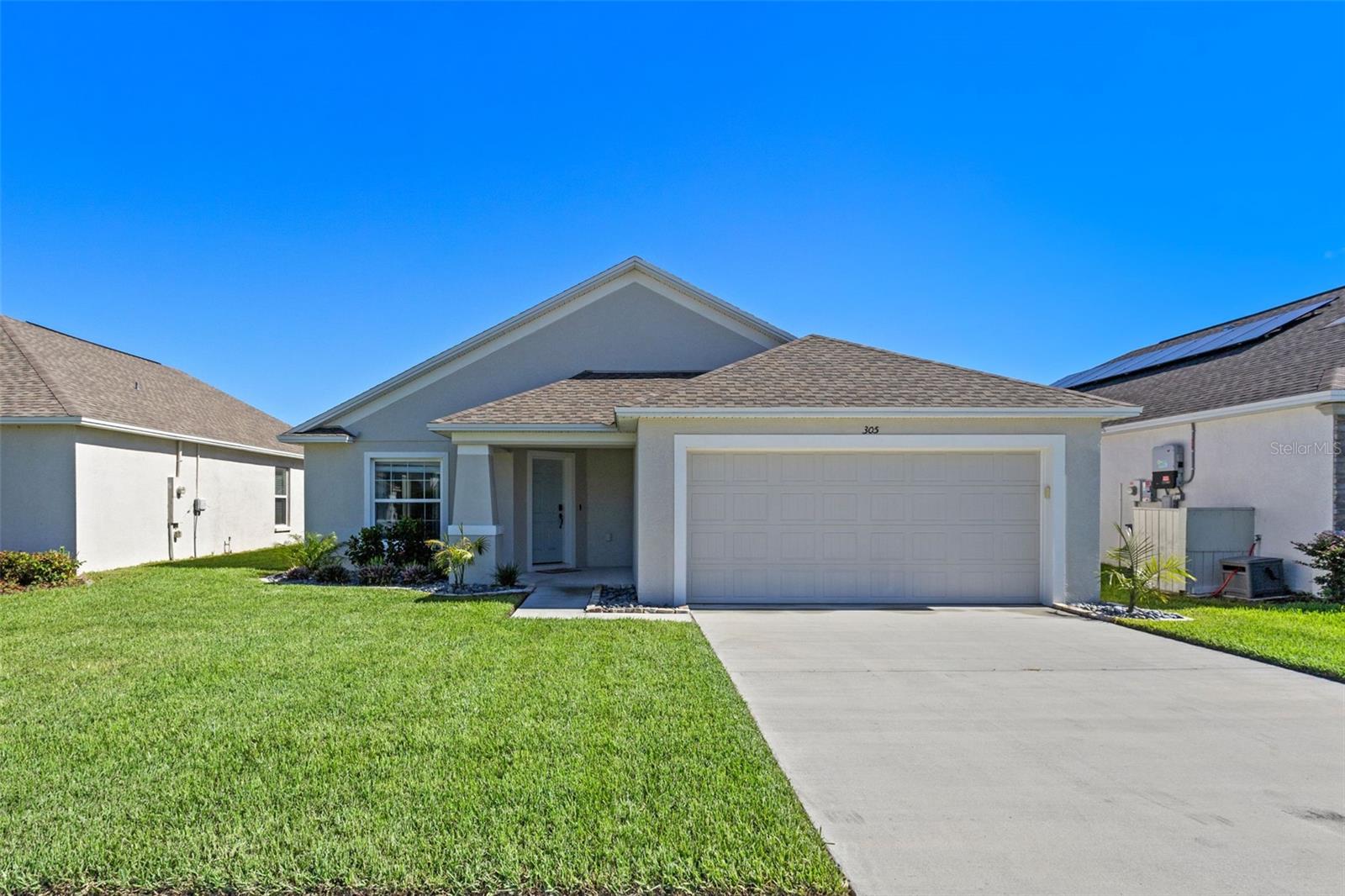 Welcome to this beautiful 3-bedroom, 2-bathroom home located in a gated, waterfront community with exclusive access to Lake Rochelle. Enjoy the benefits of a private dock, boat ramp, scenic trails, and a family-friendly playground with low HOA fees. This thoughtfully designed home features a bright, open concept living and dining area perfect for everyday living and entertaining. The modern kitchen is both functional and stylish, boasting rich hardwood cabinetry, a large center island, breakfast bar, and generous counter space. A dedicated laundry room adds extra convenience. The private primary suite is a true retreat with an ensuite bath that includes a spacious walk-in tiled shower, double vanity, and an oversized walk-in closet with a built-in organizer. Step outside to a covered patio ideal for relaxing or entertaining, with plenty of room to add your own pool. The home also includes solar panels to help reduce electricity costs, especially during the hot Florida summers. Ideally located just minutes from local grocery stores, medical facilities, and shopping, and only: 10 minutes from Historic Downtown Winter Haven 25 minutes from LEGOLAND 35 minutes from Walt Disney World 45 minutes from Universal Studios 1 hour to Orlando International Airport 1 hour 15 minutes to Tampa International Airport 1.5 hours to the Gulf Coast beaches Don’t miss this incredible opportunity to live in a lake-access community with resort-style amenities. Schedule your private showing today!