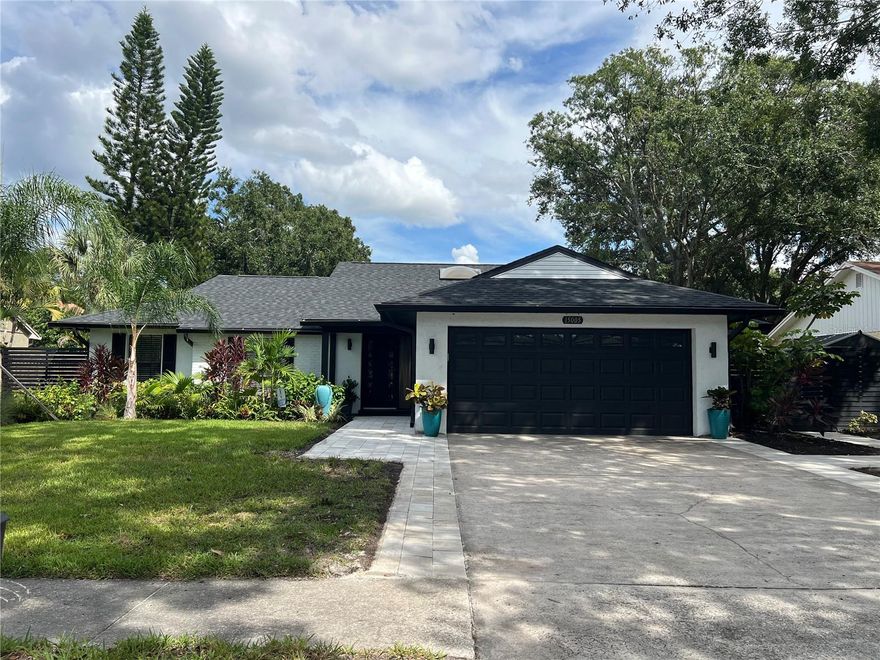 Welcome to this sleek and modern 4 bedroom 2 bathroom home in the heart of "Carrollwood" in the neighborhood of Country Place!  As you enter you will notice the classy design this home has to offer.  Soaring ceiling in your family room and plenty of nature light.  You will enjoy entertaining in this kitchen that offers all the latest style.  Stone counter tops and stainless steel appliance show off this roomy eat in kitchen adjacent to the spacious dining room with access to the screen in salt water pool and entertainment area.  Laundry room has been converted into a private work space for a work at home option.  Down the hallway you will find a lovely primary bedroom and stunning full bathroom with shower and double sink vanity.  3 additional bedroom and updated  full bathroom with a double vanity and shower/tub combo.  The outdoor space is an oasis on its own.  Fully screened in Salt water pool 2024 with concrete pavers and covered cooking/entertainment area with view of the pond.  Fire-pit 2024 and so much more.  Yard is fully fenced and meticulously landscaped,  This home is move in ready!!  Low HOA and No CDD!! Roof 2024.   Conveniently located to restaurants and shops.   This gem is a must see inside-Contact us today for your private showing.