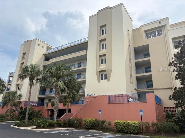 Beachside living at its best from this beautifully partially furnished 3/2 condo located on the 4th Floor at Ocean Walk in New Smyrna Beach. This light and bright condo is a corner unit with 2 balconies, one of which is located off the primary suite, that has a huge walk-in closet, an ensuite bath with dual vanities, a jetted tub, and a step-in tiled shower. The open floor plan is upgraded with brick under the bar counter and a large laundry room with lots of shelving. Located across the parking lot is the main clubhouse, pool, tennis courts & fitness center. Located just a few steps from the privately deeded walkway that leads to the no drive section of the beach! Ocean Walk is a gated community that has top-tier amenities with under-building parking including two resort-style pools, spa, a fully equipped gym, nature trails, shuffleboard, sauna, basketball & tennis courts. The clubhouse has a full kitchen located in front of the pool area with gas grills. There is a trash Chute and private storage closet on the same floor as the unit. The association dues cover cable/internet, water, sewer, trash all ground maintenance and security gate. With hurricane-impact windows and door sliders this makes beachside living stress-free. The association is pet friendly. Building 8 has recently completed its SIRS and Reserves Study with no assessments required. This unit also has a brand-new A/C unit and has never been rented out. Once you see this property, it will not be hard to Invision yourself living this low maintenance luxurious coastal lifestyle.