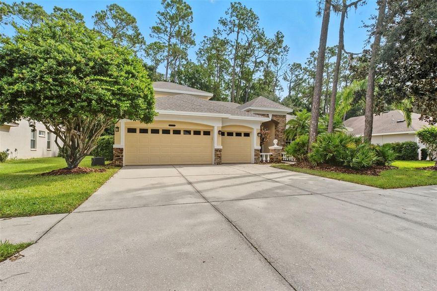 Tucked away in the gated and highly sought after community of RIVERWOODS HAMMOCK is where you will find your new dream home! 
This incredible four bed, three bath, three car garage home offers all the space and updates that make it not only beautiful but also functional. As you arrive to the home take notice of the freshly painted exterior, upscale stone accents and lush tropical landscaping, all inviting you to come on home! Walk through the double entry front doors and the spacious foyer and formal living space featuring, soaring ceilings, updated lighting fixtures, a large slider with views to the gorgeous backyard and new luxury vinyl flooring. Directly to your right you will find the office with views out to  the lush landscaping of the front yard and a double French door for privacy. Continuing onto the right and through double entry doors is the large and private owner’s suite. The owner’s suite provides the space you desire in a personal retreat as well as access to the forested backyard through a set of sliders. Features such as double trey ceilings, designer niche and new carpet add to the luxurious feel of the space. The owner’s retreat also features two large walk-in closets with shelving, a large walk-in shower, soaker tub, designated make-up space with cabinets and dual sinks with cabinets and drawers as well as a private water closet. The owner’s suite is truly a place to retreat and recharge in luxury. Step into the open family room and kitchen and find yourself in a space perfect for family activities and entertaining guests. This large space offers tons of large windows, including a slider to the backyard and new luxury vinyl flooring. The kitchen is a standout featuring beautiful solid wood 42” cabinets with crown, granite counter tops, tons of counter space including a large serving bar, granite backsplash, island with storage, walk-in pantry, designer pendant lighting as well as flush mount lighting, large stainless sink with restaurant style faucet and stainless appliances. This kitchen truly has it all! Just off of the large family room you will find a door leading to the lush backyard and a full bath with stand-up shower along with a large secondary bedroom and large closet. Towards the front of the home you find two more secondary bedrooms and a full bath giving everyone in the family their own private space. Just off the kitchen you find the large laundry room, this space has shelving for storage, a large mop sink and a HUGE storage closet! Follow the staircase up to the second-floor bonus room and let your mind wonder! This LARGE space can be just about anything you want it to be! Play room, craft room, gaming room, home schooling room, movie room, whatever your imagination can think of this space is the perfect place for you to make it happen! This INCREDIBLE home has been updated with new exterior and interior paint, new carpet and LVP, a new A/C unit upstairs AND A NEW ROOF! Enjoy the peace and quiet of this lovely neighborhood as well as all the upgrades this beautiful home has to offer. Located off Bell Shoals road and within a short distance of shopping, medical offices, schools, restaurants  and so much more. This is the dream home you don’t want to miss out on.
