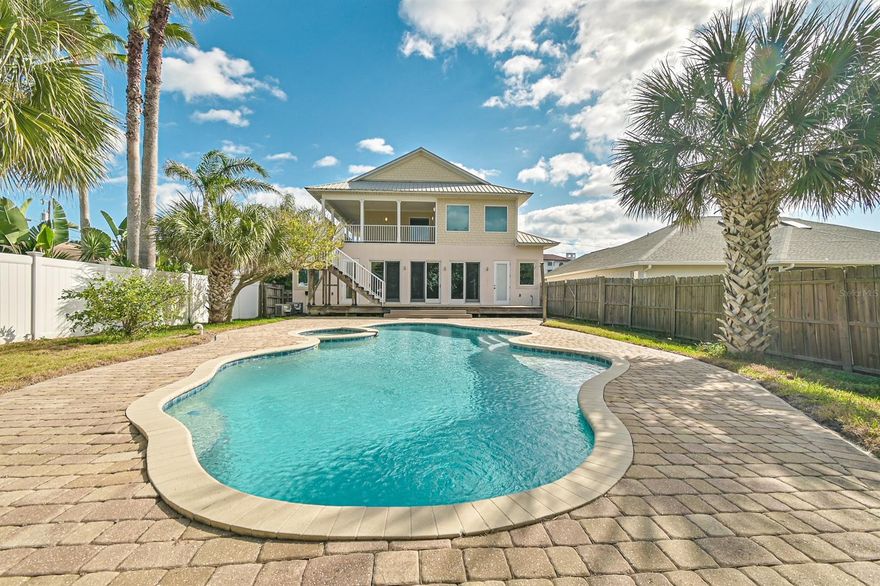 Welcome to your Custom built pool home directly across the street from the white sands of NSB. The superb design of this build was based on fun, entertainment, and relaxation! 3 bed, 4 FULL baths and 2 flex rooms that can be utilized as additional bedrooms, den, office, art studio, or however you choose. The possibilities are endless. Huge paver driveway with separate garages on each side of the covered entry. Downstairs features a foyer/sitting room with a Beautiful wood staircase and a stone see through gas fireplace to the main living area with dual ceiling fans. Be sure to take notice of the little details including custom trim work and crown molding throughout. Continue into the family room for a spectacular view of the saltwater pool through 3 sets of impact glass sliders. The chefs kitchen is equipped with all SS appliances including a built in oven and microwave, trash compactor, and ice maker built into the island. Granite counters, custom tile backsplash, and prep sink are a few more reasons to love the kitchen. Off the family room is one of the 2 master suites with full bath and flex area that can be private living quarters. The backyard is an absolute show stopper! Everything is oversized from the pool itself to the incredible paver deck large enough for a crowd and the extensive wood deck. Outdoor shower perfect to rinse off the sand before entering the pool. Climb the exterior stairs to show stopper #2! The one of a kind second floor wrap around deck offering ocean views, the ocean breeze, and a panoramic view of New Smyrna Beach. Upstairs offers 2 more bedrooms, 2 full baths, and the 2nd flex area with access to the upper deck overlooking the pool. The master bath offers incredible natural light, dual granite vanities, and plenty of closet space. Newer AC units, Beautiful metal roof, Tile Throughout, Tankless Hot Water Heater and so much more! All sizes are approx. All information deemed accurate but cannot be guaranteed. ;Water: City