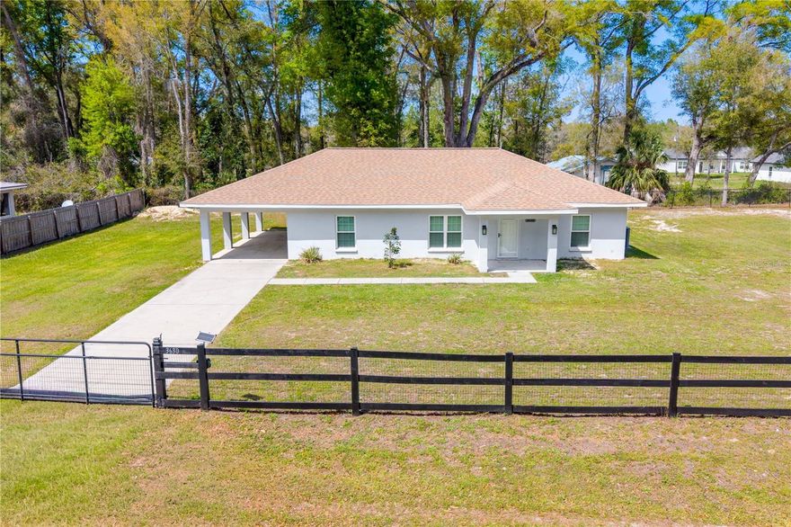 Welcome to this 3-bedroom, 2-bathroom home nestled in the peaceful town of Bell, FL sitting on a fully fenced 1/2 acre lot with electric gate on paved road! This 2020 Block/Stucco home was built with durability in mind. This adorable home boast an open floor plan, luxury vinyl plank through out, kitchen with granite tops, stainless steel appliances, a dining area that opens to the outdoors through the french doors, onto a large screen porch creating an easy flow for indoor-outdoor living. The spacious primary suite includes a private bath with a large shower, and a large vanity with dual sinks. Additional bedrooms are nicely sized, making this home ideal for family or guests. Located less than mile to restaurants and schools. NO HOA and a great yard, plenty of room for your toys & pets. Call us to tour this great property.