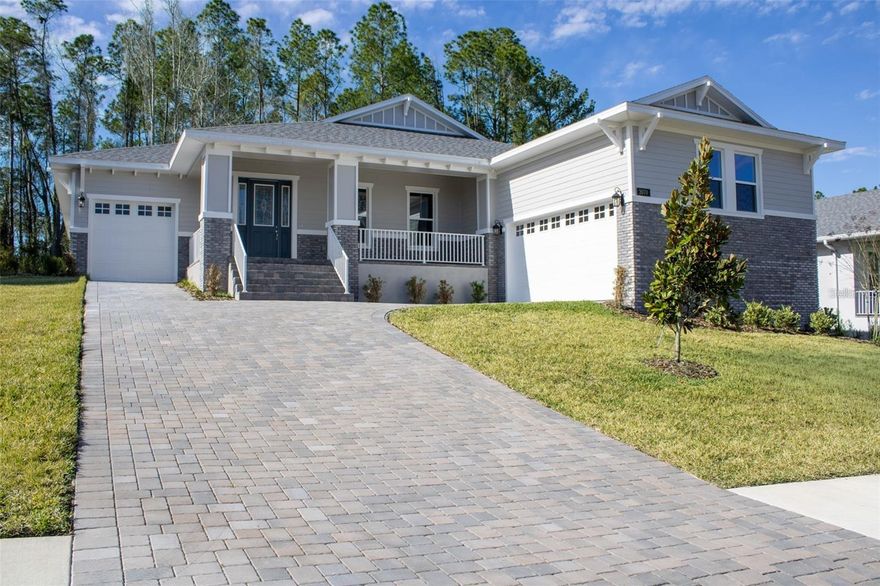 One or more photo(s) has been virtually staged. MOVE-IN READY! Welcome to 3970 Southern Valley Loop — a beautifully crafted Azalea model by Spire Homes, a semi-custom builder, located in the sought-after, guard-gated Southern Hills Plantation in Brooksville, FL. Set on a landscaped, 255-foot deep homesite with mature trees, this one-story Craftsman delivers 2,606 sq ft of refined living with exceptional outdoor space and a split 3-car garage — a two-car garage and a separate one-car garage — providing flexible storage and vehicle options.
The pavered driveway and front porch create a warm first impression, and the open floor plan inside delivers on every expectation. The great room, kitchen, and dining area connect seamlessly, with the chef's kitchen serving as the true centerpiece: five-burner gas cooktop with vented hood, built-in convection oven and microwave, soft-close real wood white shaker cabinets, quartz countertops, a large island with breakfast bar seating, subway tile backsplash, and under-cabinet lighting. The home features 3 bedrooms, 3 full baths, and a spacious flex room that adapts as a home office, workout room, or formal sitting area.
The split floor plan provides privacy throughout. The Owner's Suite features two walk-in closets, double sinks, a soaking tub, and a separate shower. The second bedroom offers its own private bath and walk-in closet. Throughout the home: 8-foot doors, 5.25" baseboards, lifetime-warranty LVP flooring in all main living areas, tile in all wet areas, tray ceilings, and a tankless gas water heater. The massive covered rear lanai is pre-plumbed for an outdoor kitchen and overlooks a deep, tree-lined backyard with ample space for a future pool.
Southern Hills Plantation is a guard-gated golf and lifestyle community featuring a Pete Dye 18-hole Signature Golf Course rated among the top 100 residential courses in the U.S. by Golf Week. Community amenities include a resort-style pool, Har-Tru clay tennis courts, pickleball courts, full-service fitness center, driving range, chipping and putting greens, a 6-hole par-3 course, walking trails, and a plantation-style clubhouse with formal and casual dining. Located just off US-41 and the Suncoast Pkwy with Tampa International Airport approximately 45 minutes away. Use builder's preferred lender for a closing cost credit!