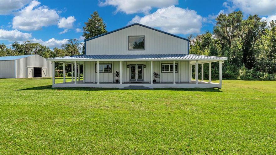 Price improvement AND $20,000 Credit offered at closing for rate buy-down, closing costs, property upgrades, etc! Country living, but close to the city?! Welcome to the spacious estate you've been searching for... 5 acres directly off Kathleen Road in Lakeland with NO HOA, 6,000+ square foot custom built "Barndominium," 40x60 Barn and a secondary house. The main home offers 4,200 square feet of living space, featuring 4 bedrooms and 4 bathrooms. The entertaining space stands out downstairs with a wrap around porch to view spectacular sunsets, huge sun-soaked living room and open dining and family room next to the updated kitchen with bar seating, walk-in pantry, new stainless steel appliances, all wood cabinets and granite countertops. The primary suite offers a large walk in closet and remodeled bathroom with double vanities and deluxe tiled shower & glass enclosure. The laundry room and mud room are conveniently positioned near the guest bath and additional oversized guest bedroom. Upstairs, it feels like another world... Gigantic bonus space/living room with new carpet, a Kitchenette/Wet bar and two bedrooms each with their own brand new ensuite bathrooms. The whole home has been updated with brand new flooring, updated light fixtures, fresh paint, new plumbing fixtures and new hardware. Additionally, there are lots of air conditioned storage closets, an enclosed storage room, two AC units, crown moulding and a brand new water heater. The property is fenced in and partially cleared, making it perfect for trucks, toys, animals and agriculture. The secondary house has its own electric meter and address, so it could be fixed up as a guest cottage or torn down and re-built. With the huge barn, the possibilities for this property are plentiful and it is close to medical facilities, shopping, recreation and the I4. Come live your country dream at 4141 Kathleen Road!