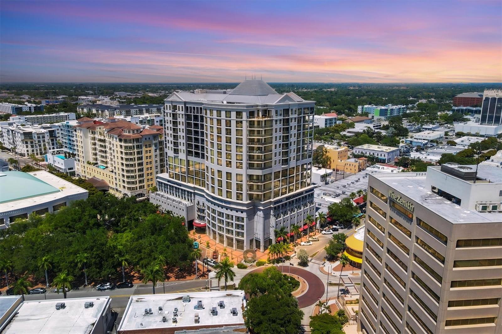 Located in the heart of downtown Sarasota, this light-filled 15th-floor corner residence located at the Plaza at Five Points offers 2,356 square feet of luxury living. The spacious layout features 2 bedrooms, 2.5 baths with a den and an open-concept living area. Take in breathtaking 180-degree views of Sarasota Bay, the John Ringling Causeway, Longboat Key, and Siesta Key from your oversized, west-facing balcony—perfect for enjoying the sunset. The gourmet kitchen is equipped with cherry cabinetry, granite countertops, built in oven, a warming drawer, and a breakfast bar, while the primary suite includes custom closet storage and a spa-like bath. Other highlights include a new washer and dryer, new hot water heater, two deeded garage parking spaces, and an air-conditioned storage unit.
Enjoy premier building amenities including a front desk steward, on-site management, security system, heated pool and spa, fitness center, grill gazebo, guest suite, community room with catering kitchen, and conference room. The HOA covers basic cable, water, sewer, and bi-annual A/C maintenance. Just steps from Selby Library, Whole Foods, Starbucks, the Farmers' Market, and Sarasota’s best dining and arts venues—this pet-friendly building offers the ultimate in downtown Sarasota living, just minutes from St. Armands Circle, area beaches, and SRQ Airport.